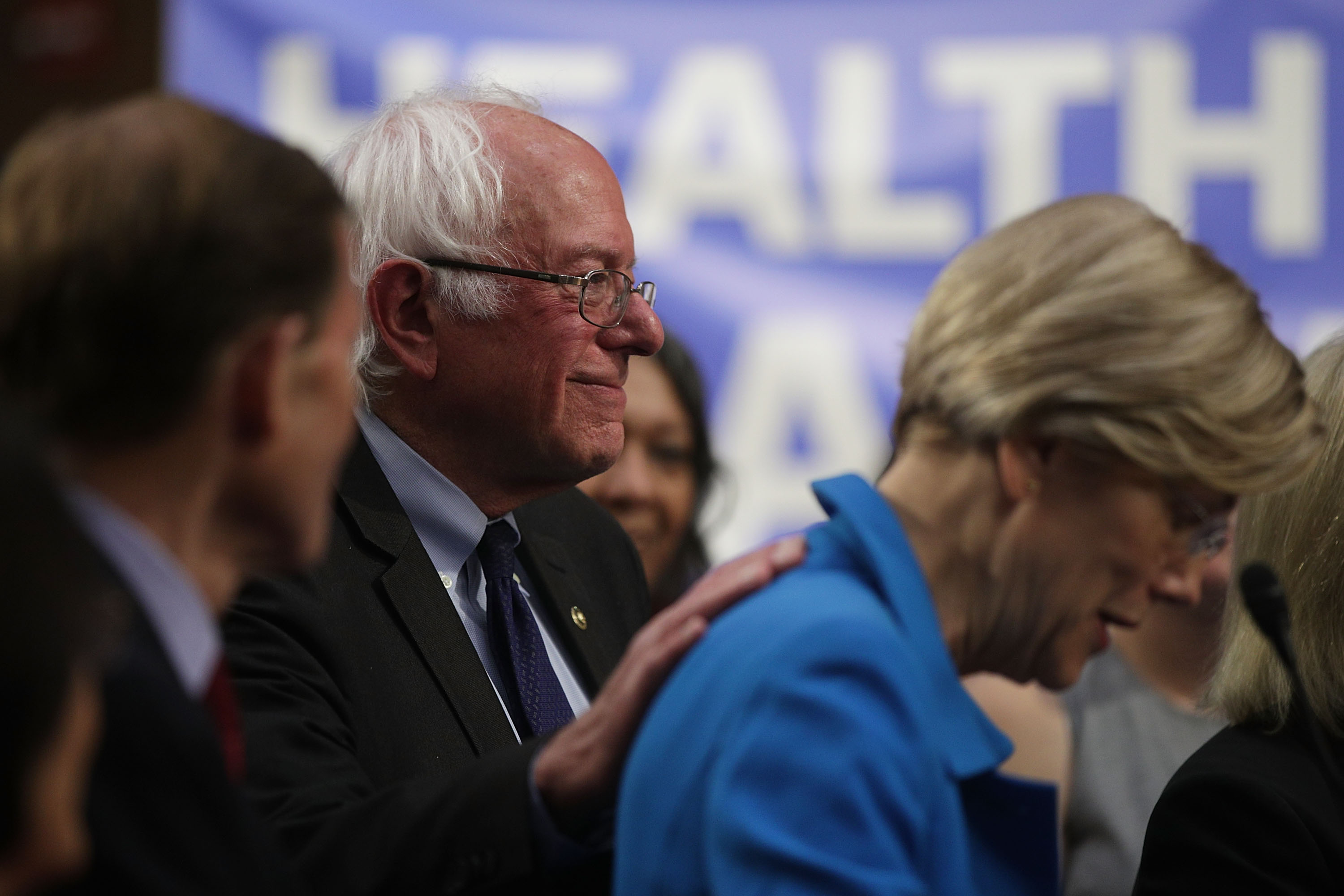 Senator Bernie Sanders patted Senator Elizabeth Warren’s back during an event on health care on Sept. 13.