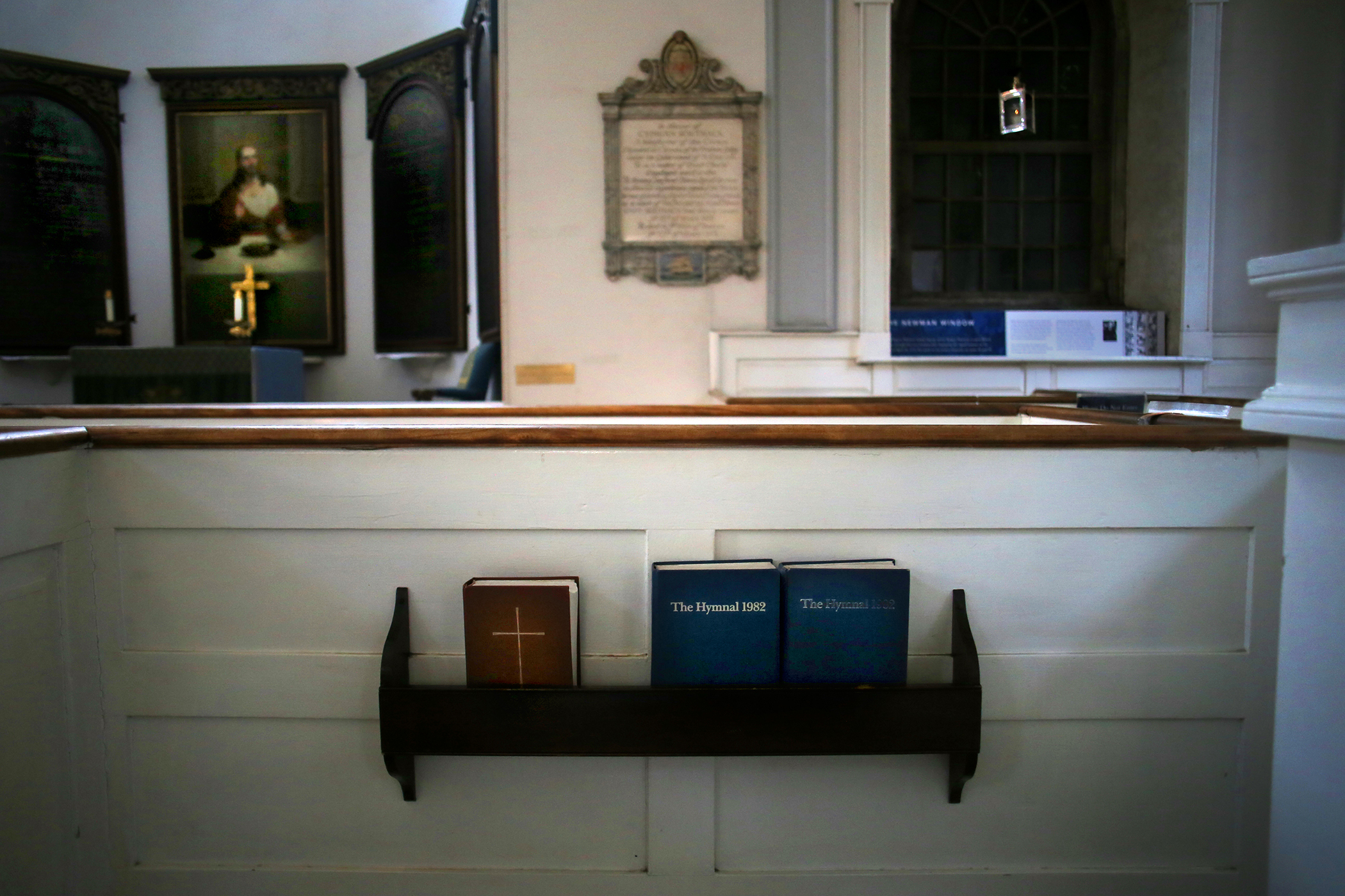 A commemorative sign in Old North’s pew 13 (above), which is where Newark Jackson sat during services, will be replaced with updated findings about the slave trader.