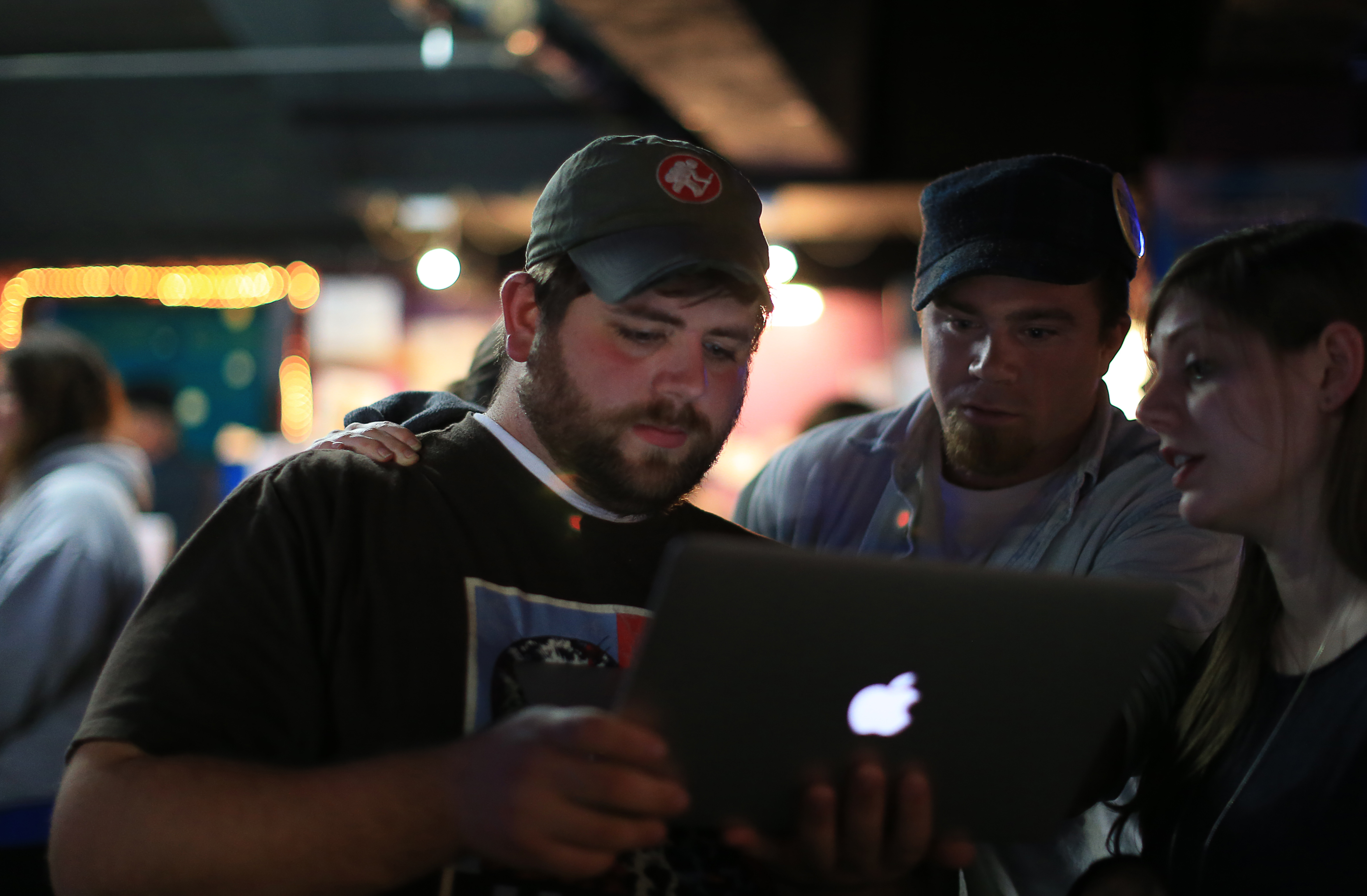 Joseph Catricala, left, John Rogers, middle, and Elizabeth Fitzgerald looked at the disappointing results of their casino repeal efforts, while at Pockets Billiards Club in East Boston.