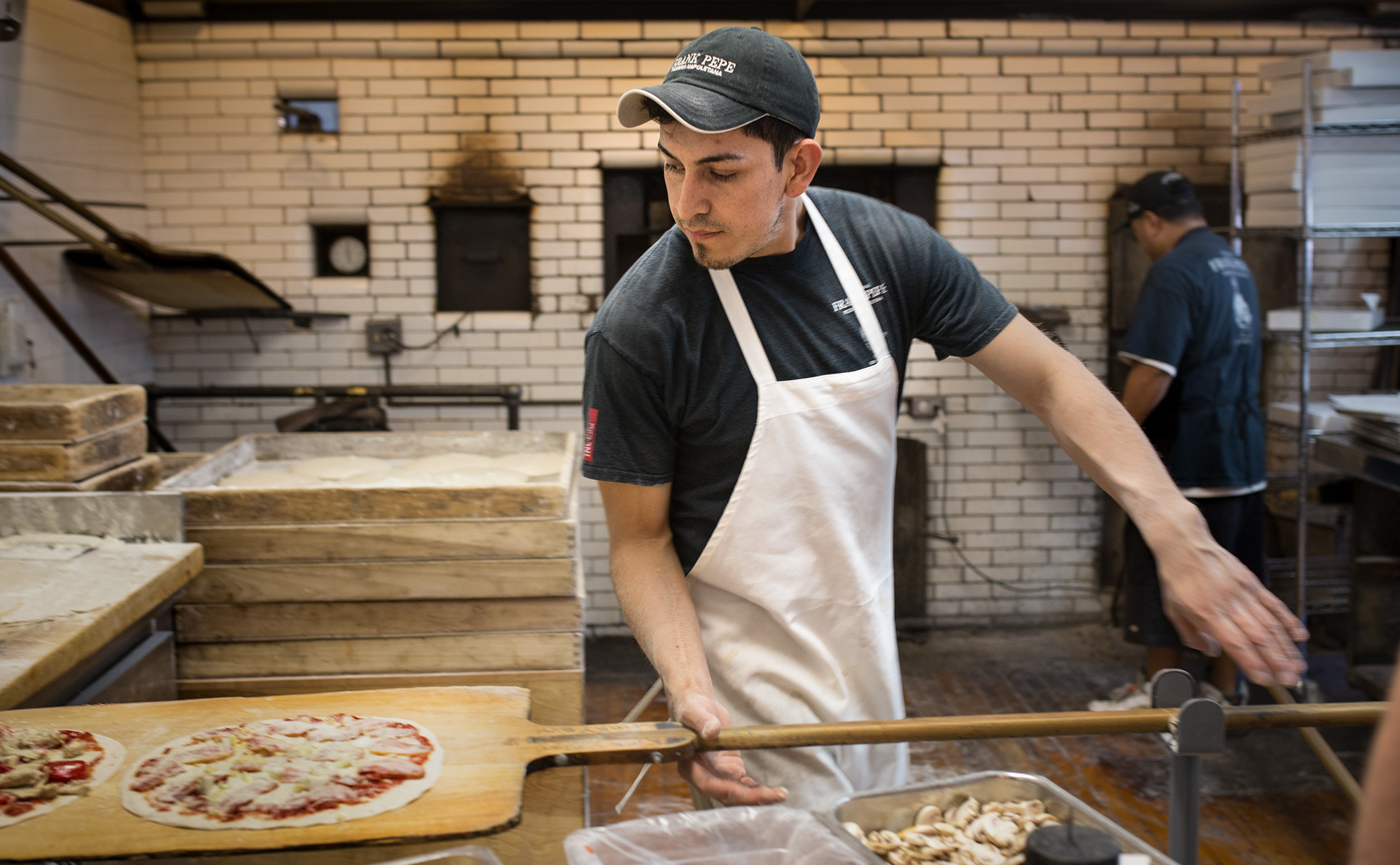 Sergio Juarez prepares pizzas for the coal-burning oven at the original Frank Pepe Pizzeria Napoletana in New Haven.