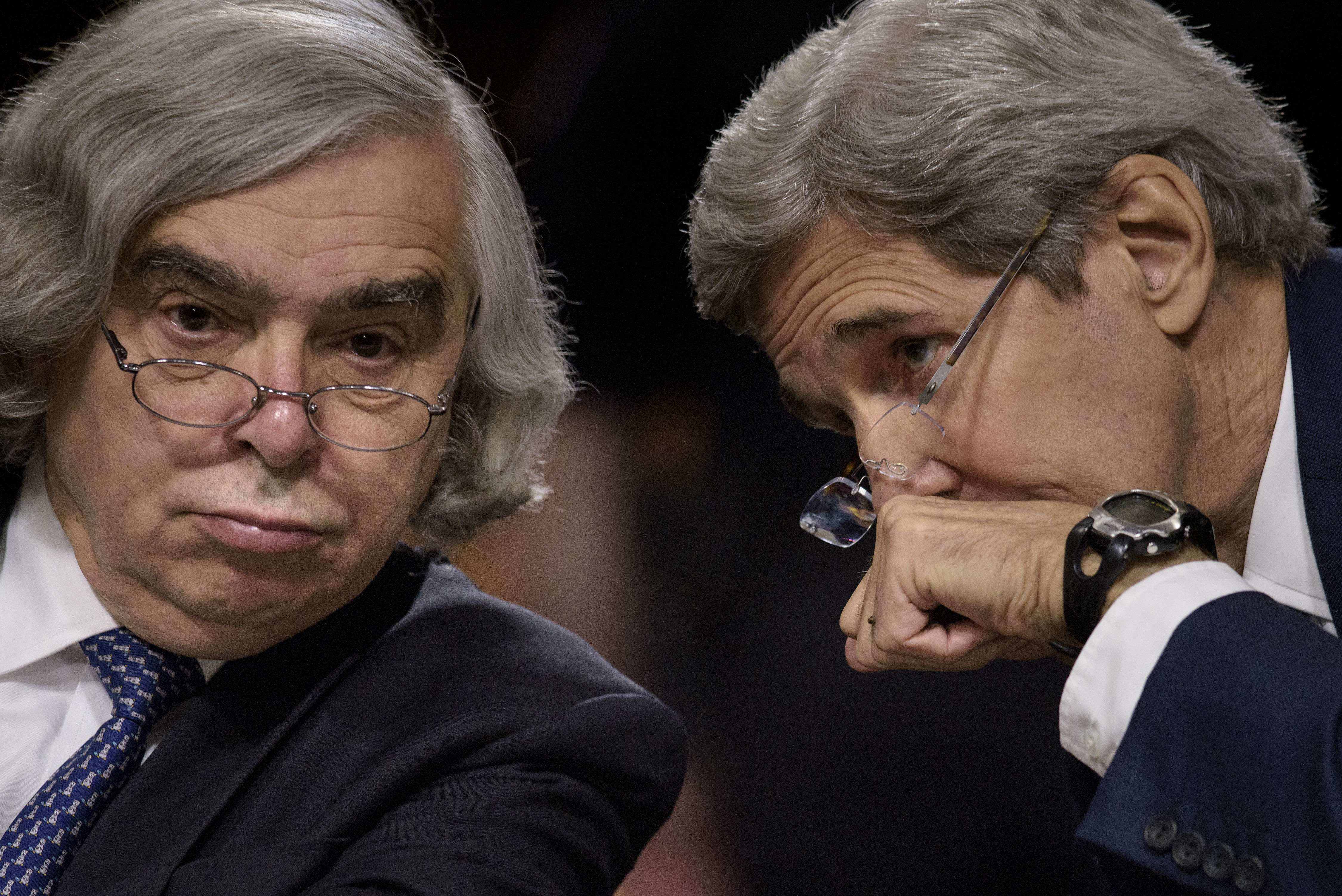 John Kerry (right) whispered to former US Secretary of Energy Ernest Moniz during a hearing of the Senate Foreign Relations Committee on Capitol Hill in July 23, 2015.