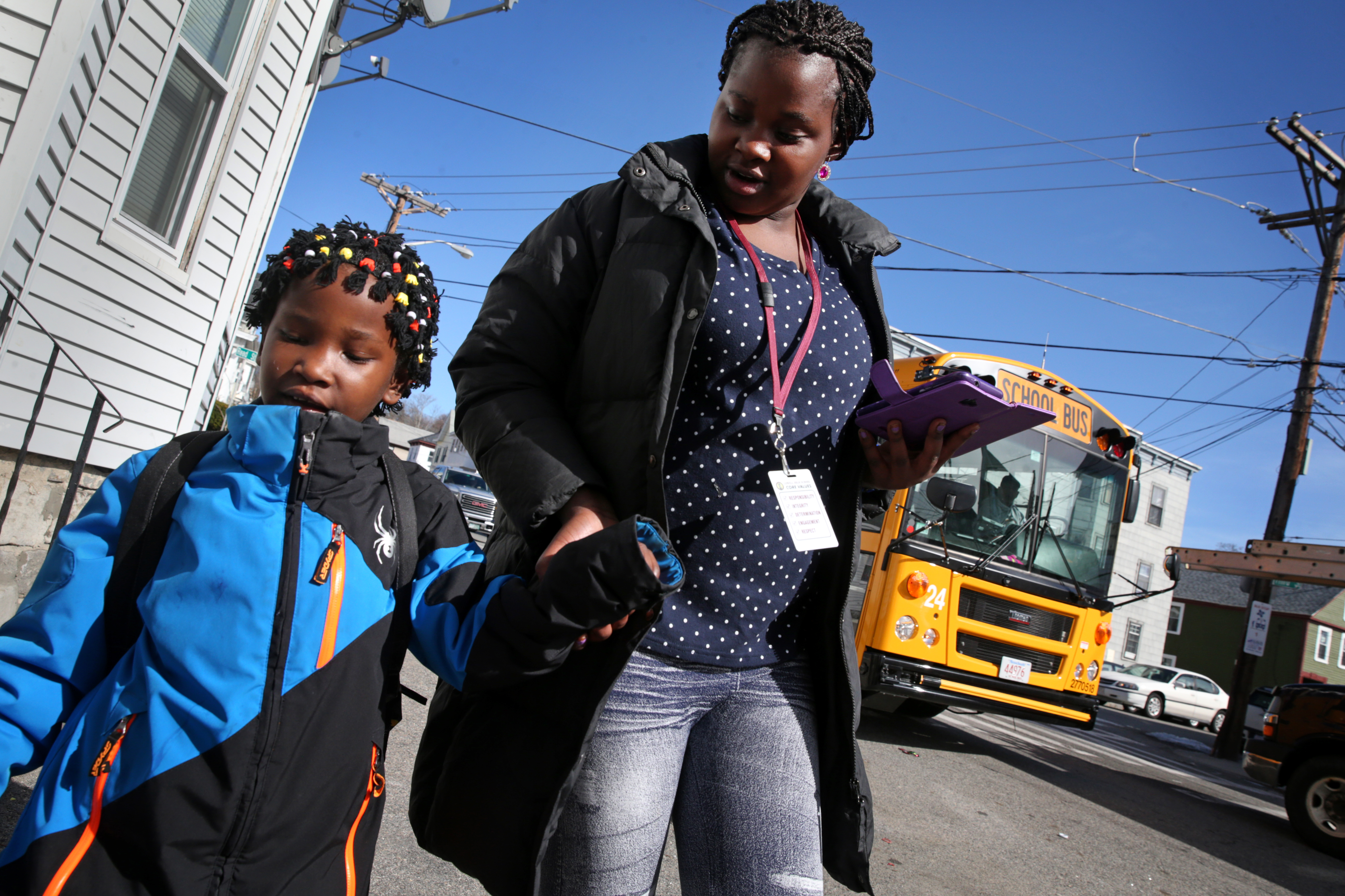 Maria Uwimana walked her little sister Sarah Bayavuge home from the bus stop after school.