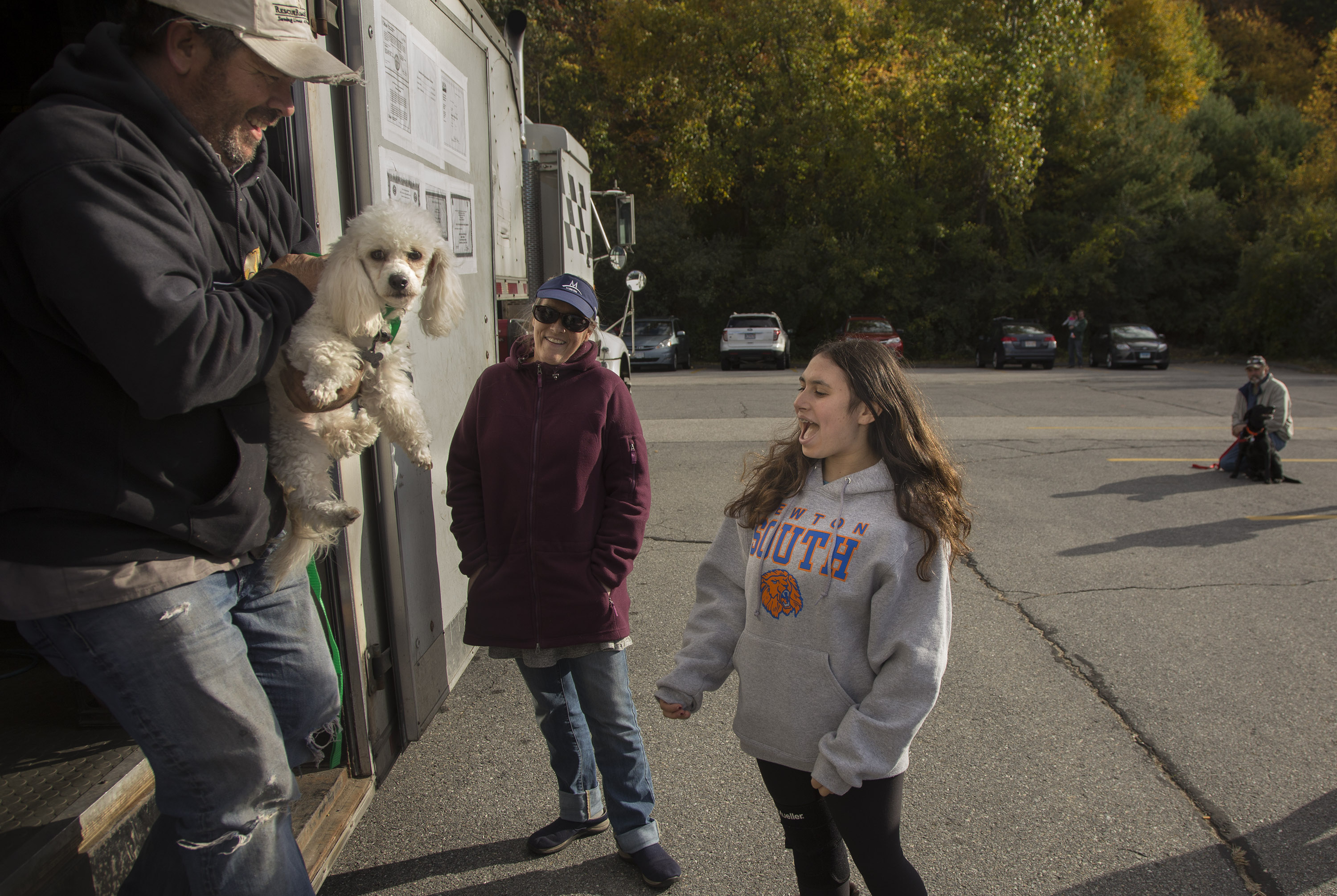 Gavi Azoff, 14, meets her new dog, Jessie, delivered by Greg Mahle.