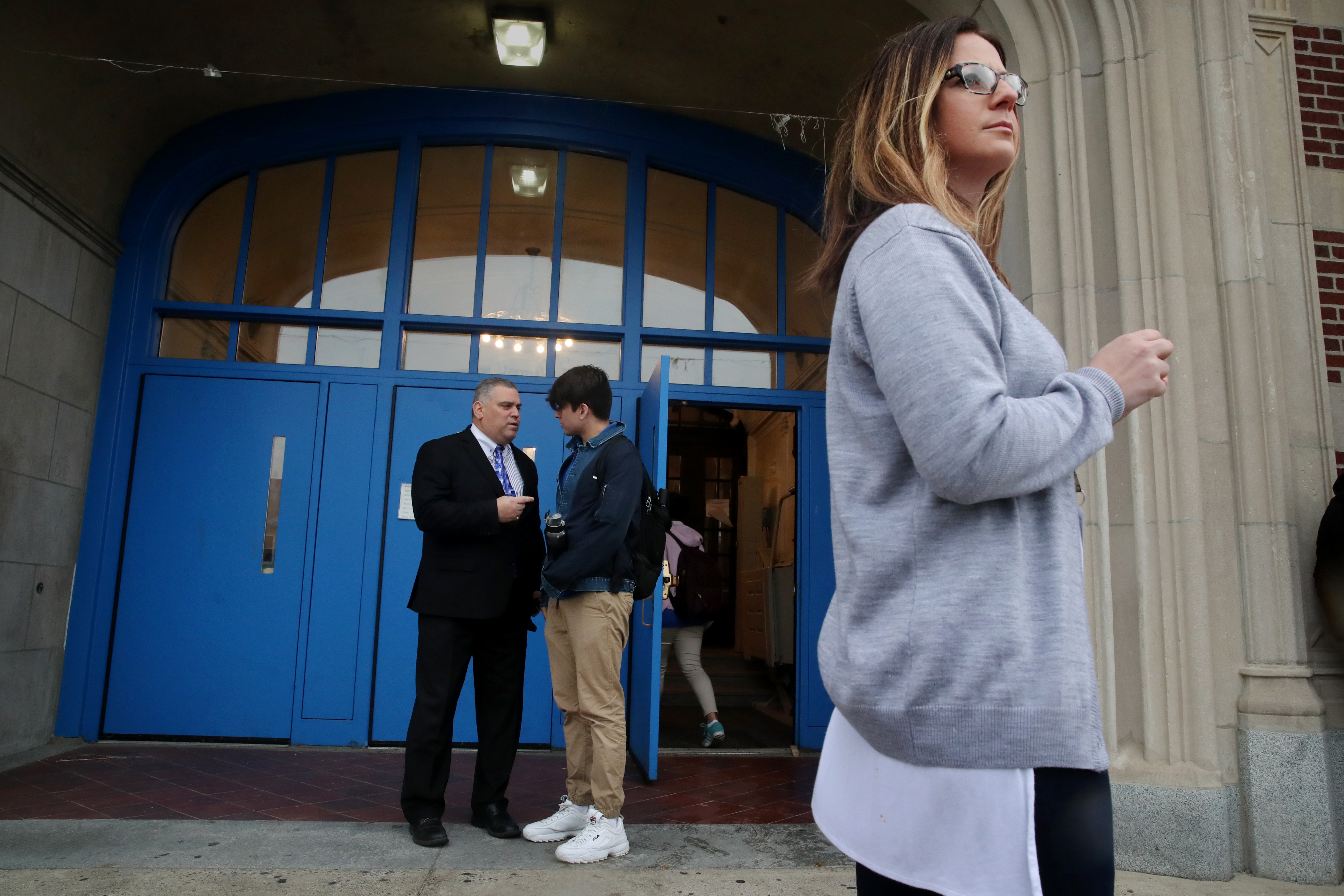 Guidance Counselor Jacquelyn Indrisano (right) and Headmaster Phillip Brangiforte greeted students arriving at East Boston High School.