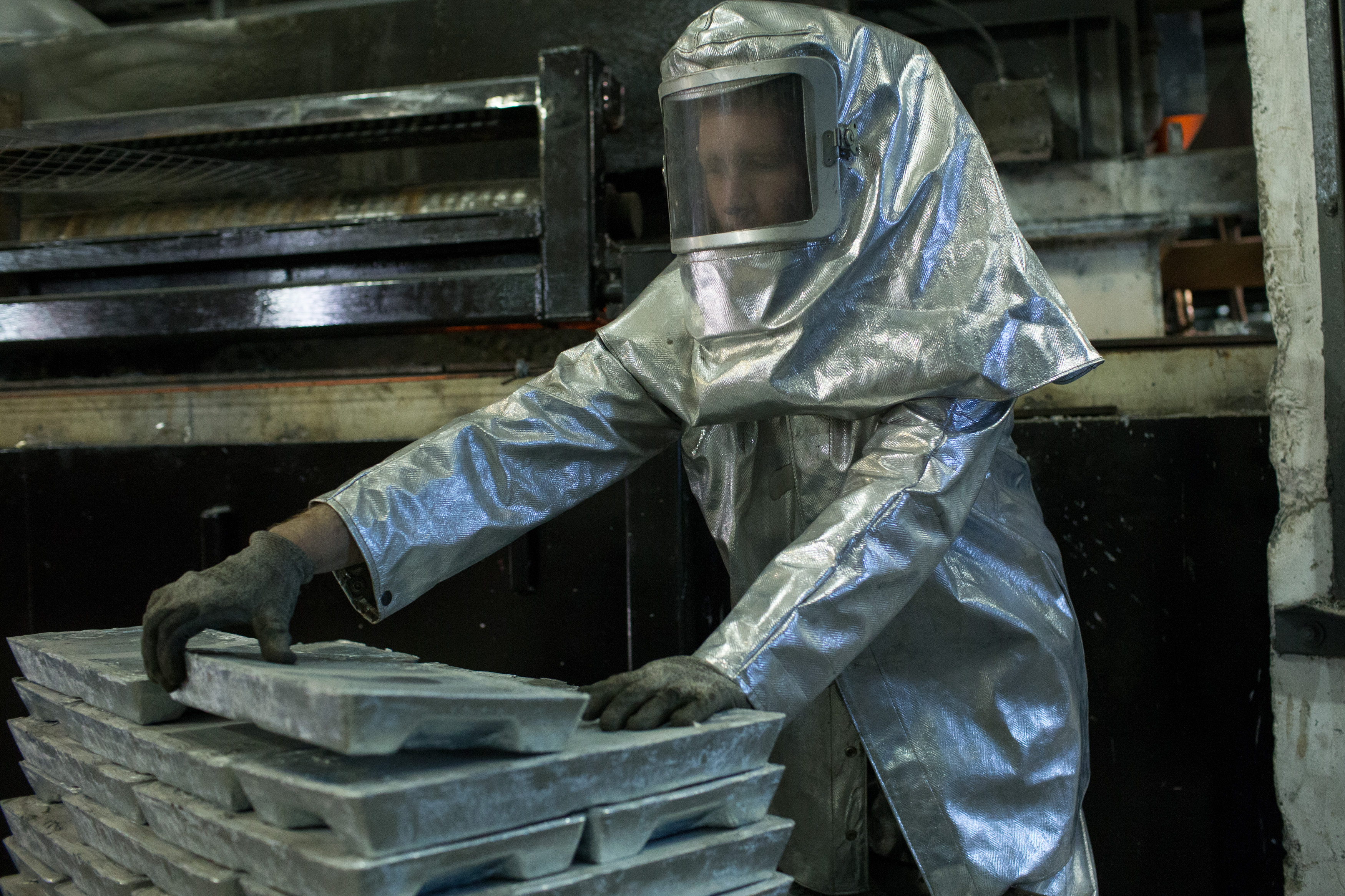 Brian Boucher moved zinc ingots toward a galvanizing tank inside the Riverdale Mills factory.