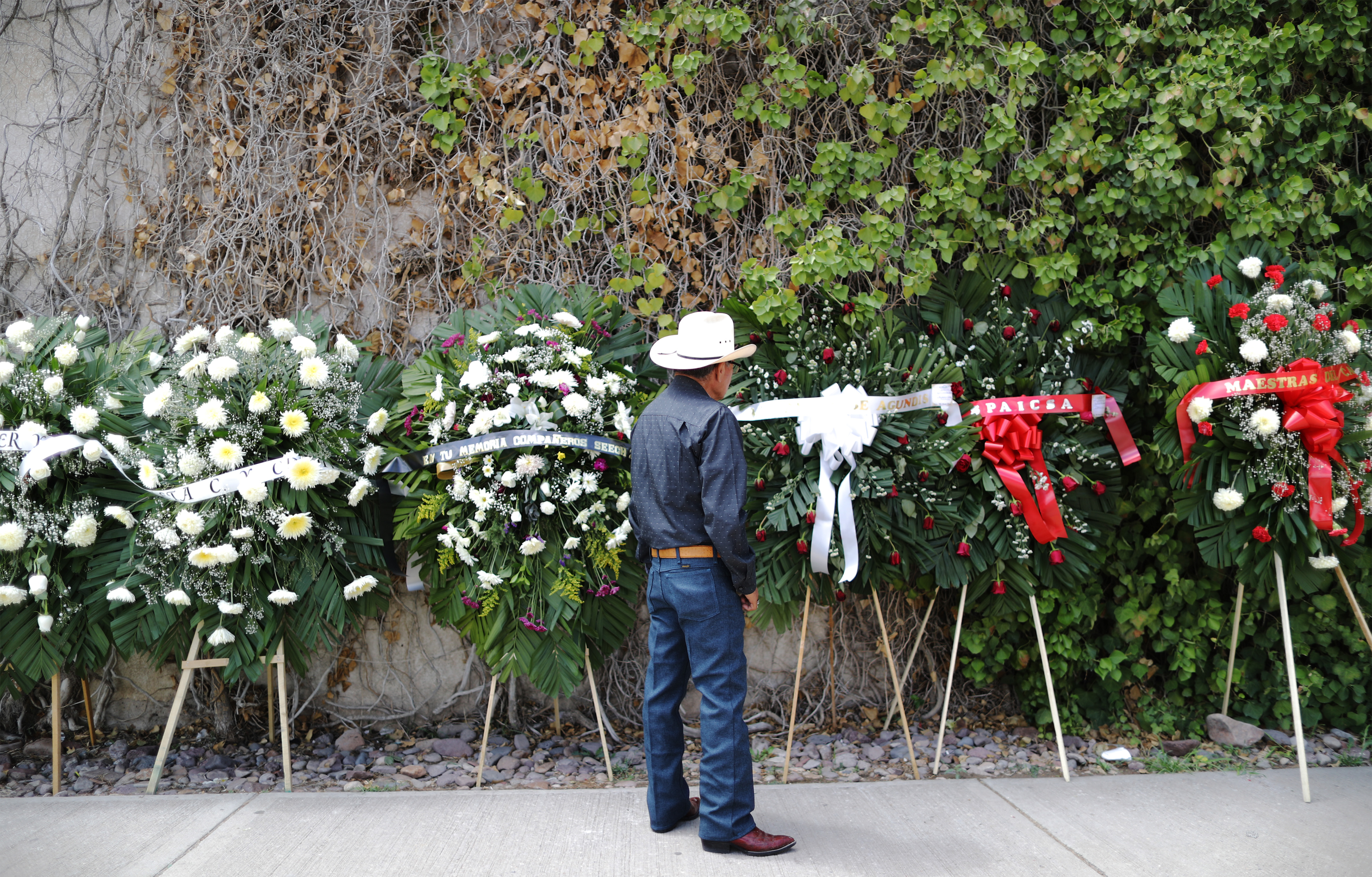 Leopoldo Mendoza Marquez looked at a flower display prior to the funeral of his sister, Elsa Mendoza Marquez, on Thursday in Ciudad Juárez, Mexico. Marquez was one of the victims of the massacre, which took place across the US border in El Paso, Texas.
