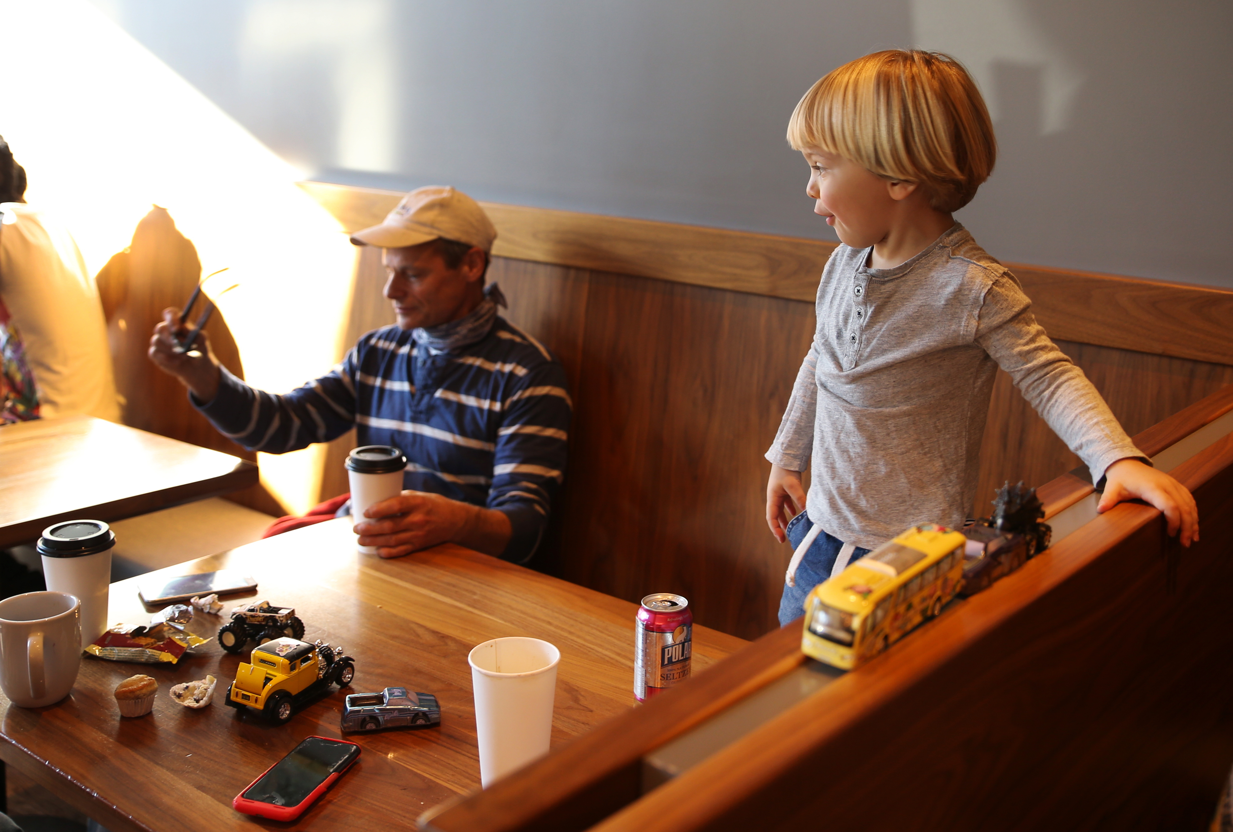 Avery Rosenberg, 2, of Newton played with his toy cars as Keith Faso of Newton watched over him at Central Café + Restaurant.
