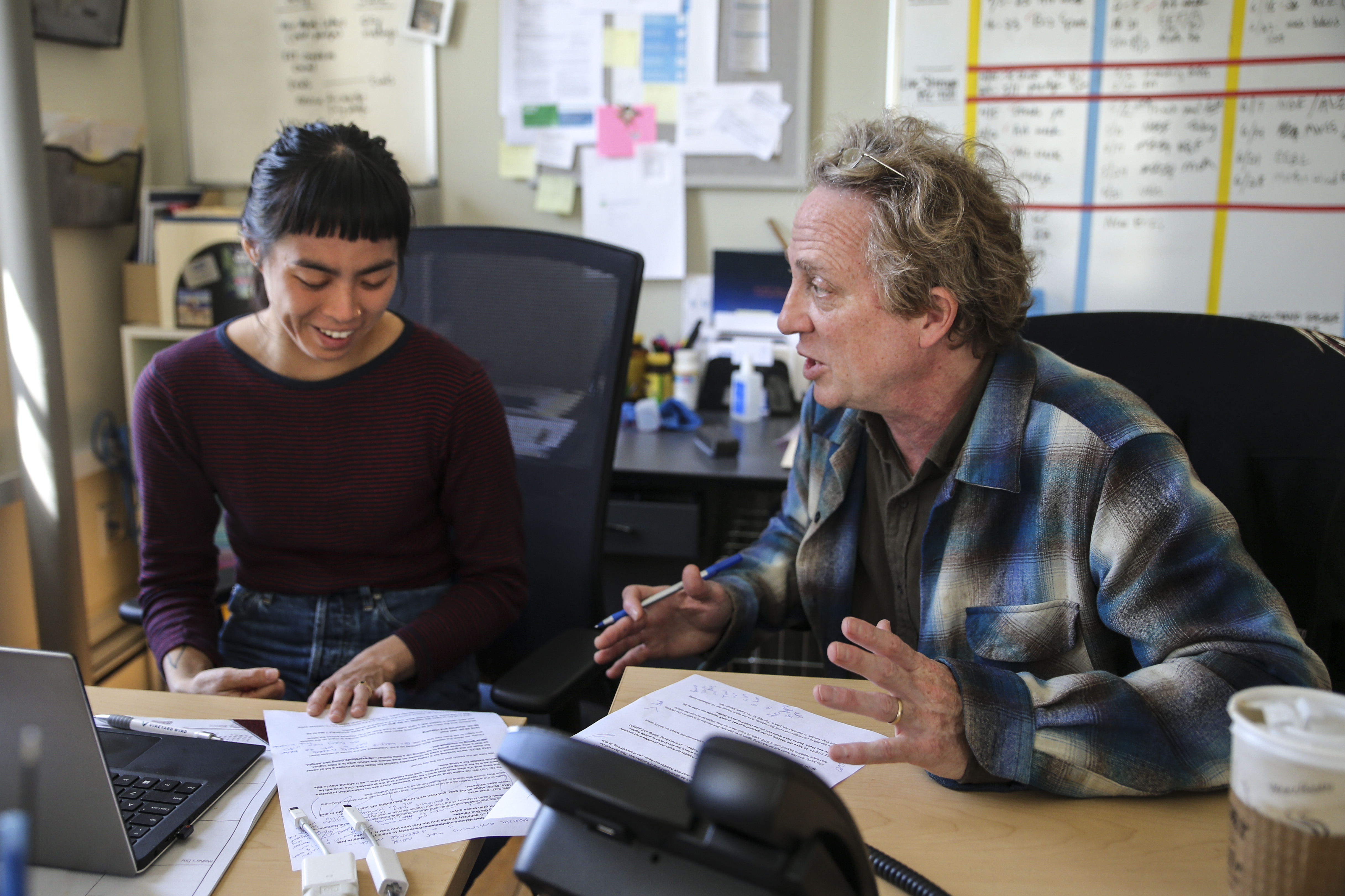 Steve Junker (right), the managing editor of local news at WCAI, helped edit a story with Sarah Mizes-Tan (left), the only full-time general assignment reporter at the station, in Woods Hole.