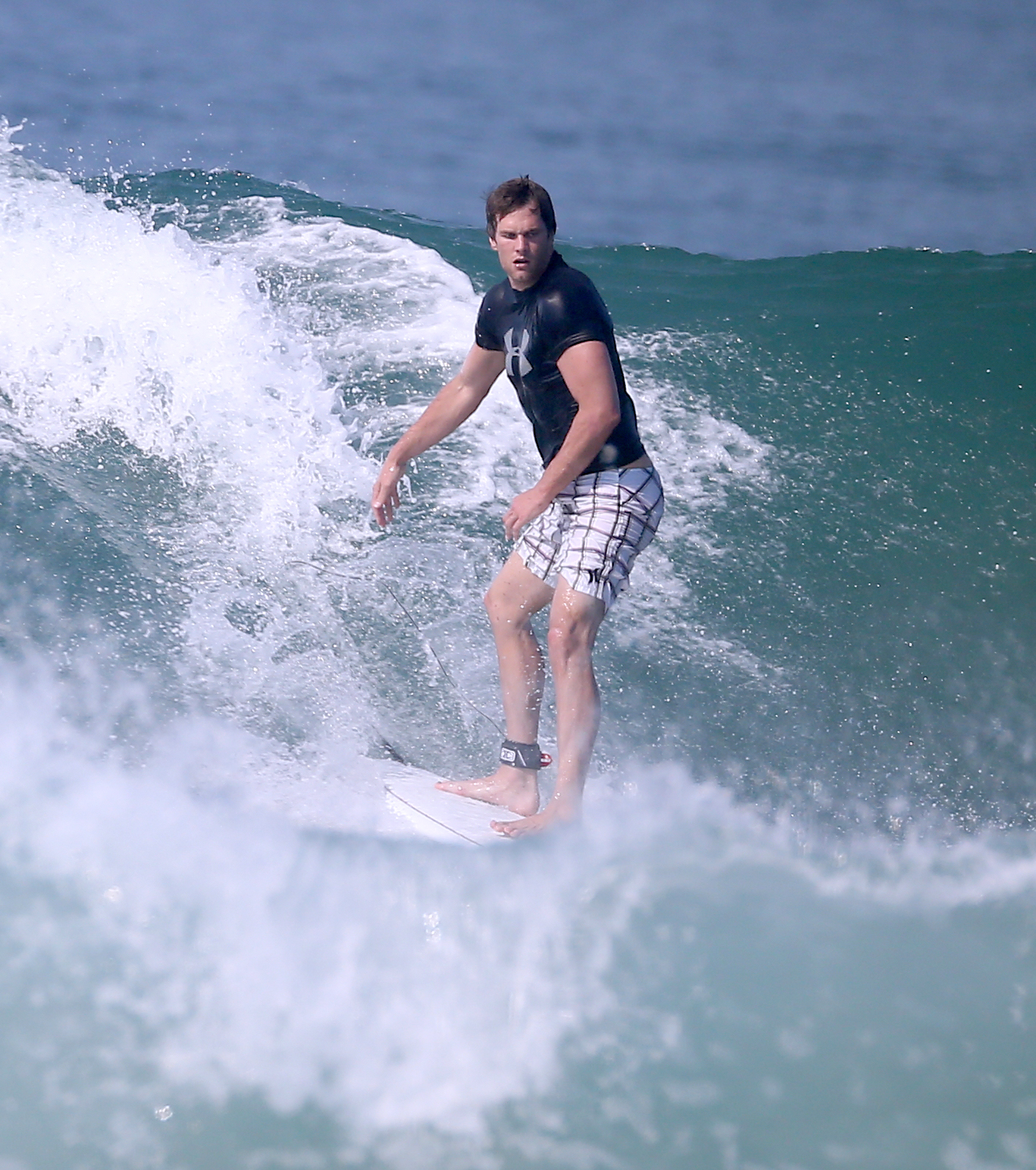 Tom Brady surfing in Costa Rica with his wife, Gisele Bundchen, who cheered for her husband when she wasn’t busy riding a wave herself.
