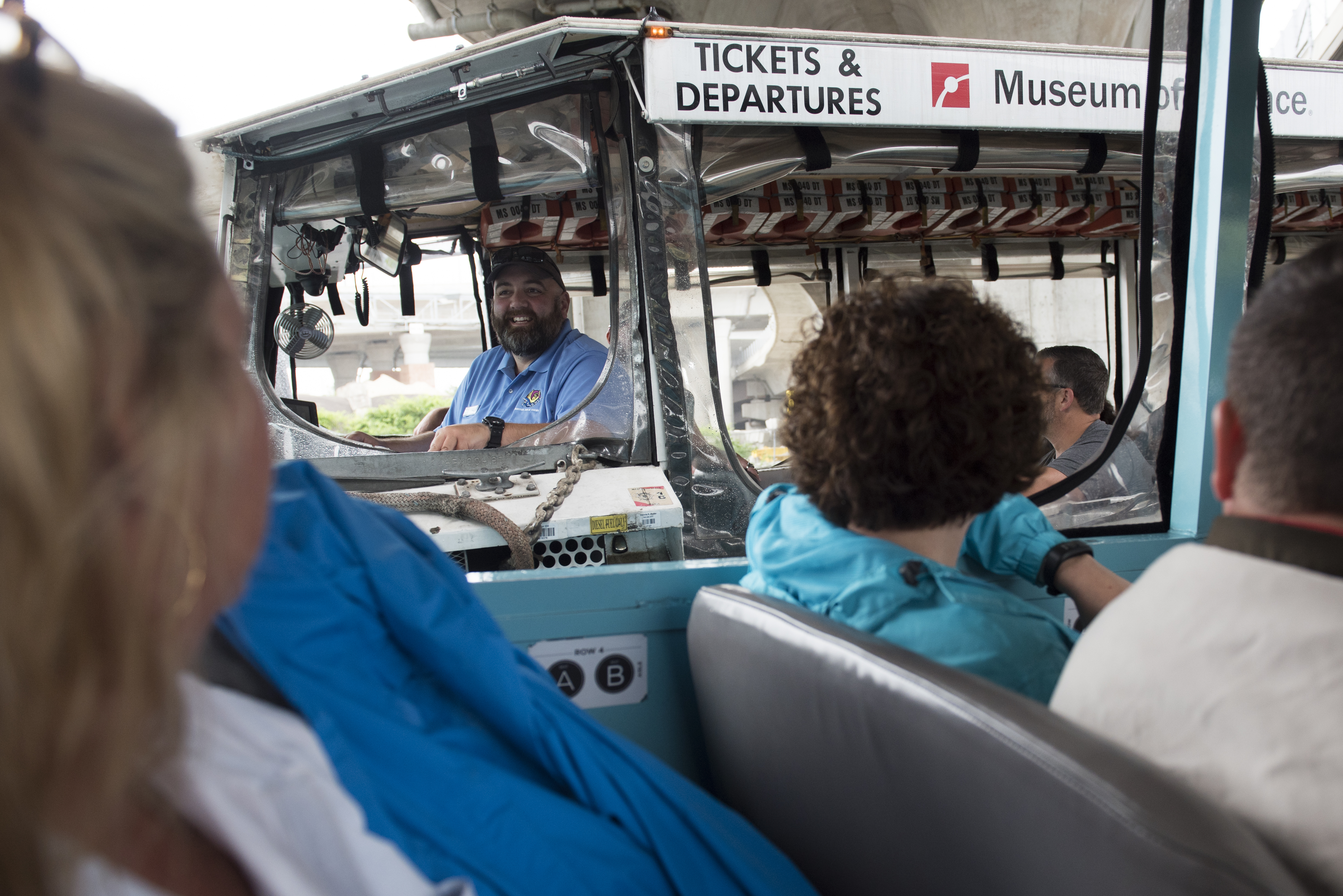 A tour boat driver stopped to laugh with the tour guide from another duck tour.