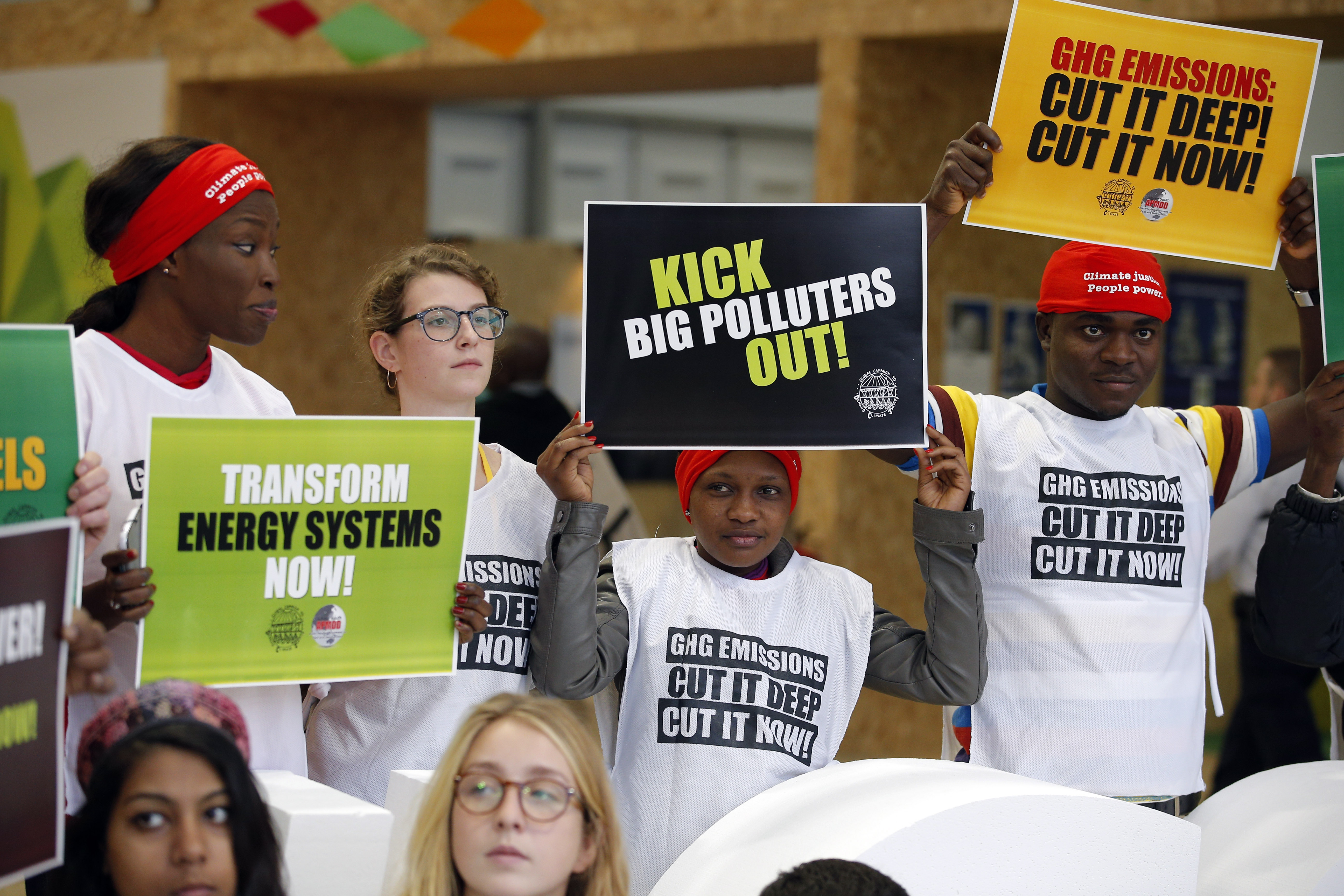 Activists protesting against polluters held banners at the Climate Generations Areas as part of the United Nations Climate Change Conference in Le Bourget, north of Paris.