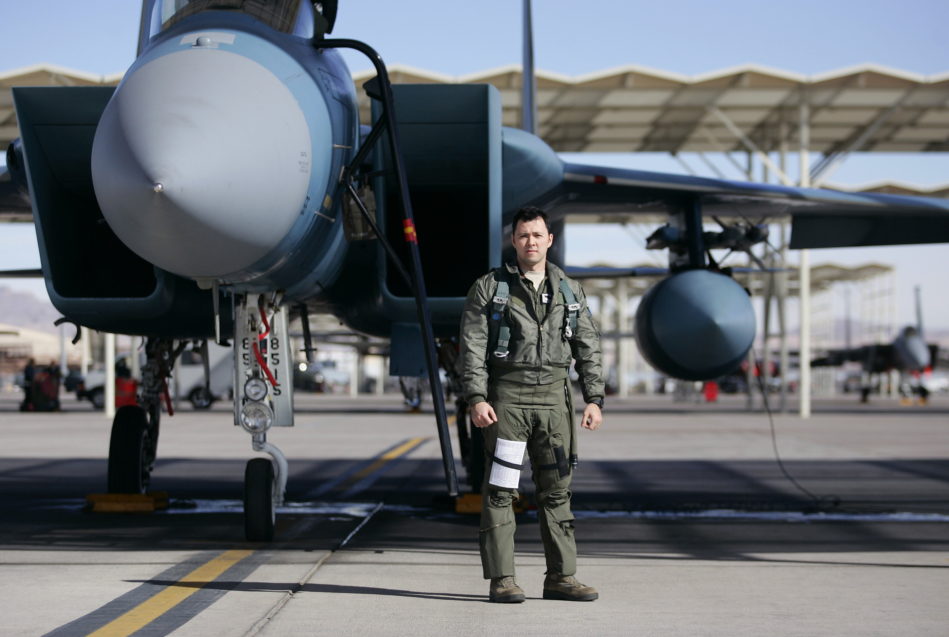Major Scott Snider stood near his F-15 fighter jet at Nellis Air Force Base in Nevada. In training he plays the enemy target, replicating what a foe might do.