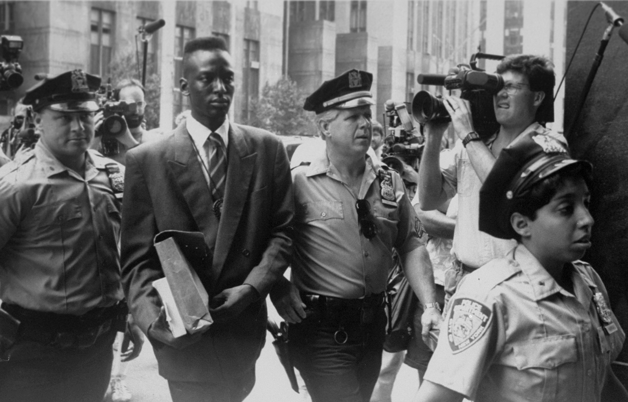 Yusef Salaam is escorted by police in 1989.