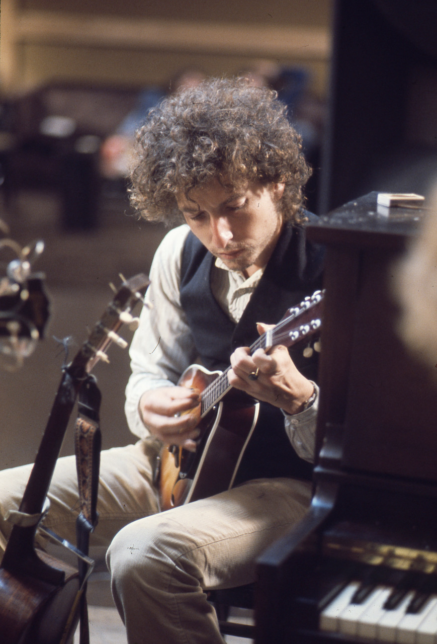 Bob Dylan is shown playing the mandolin during the recording sessions for “Blood on the Tracks.”