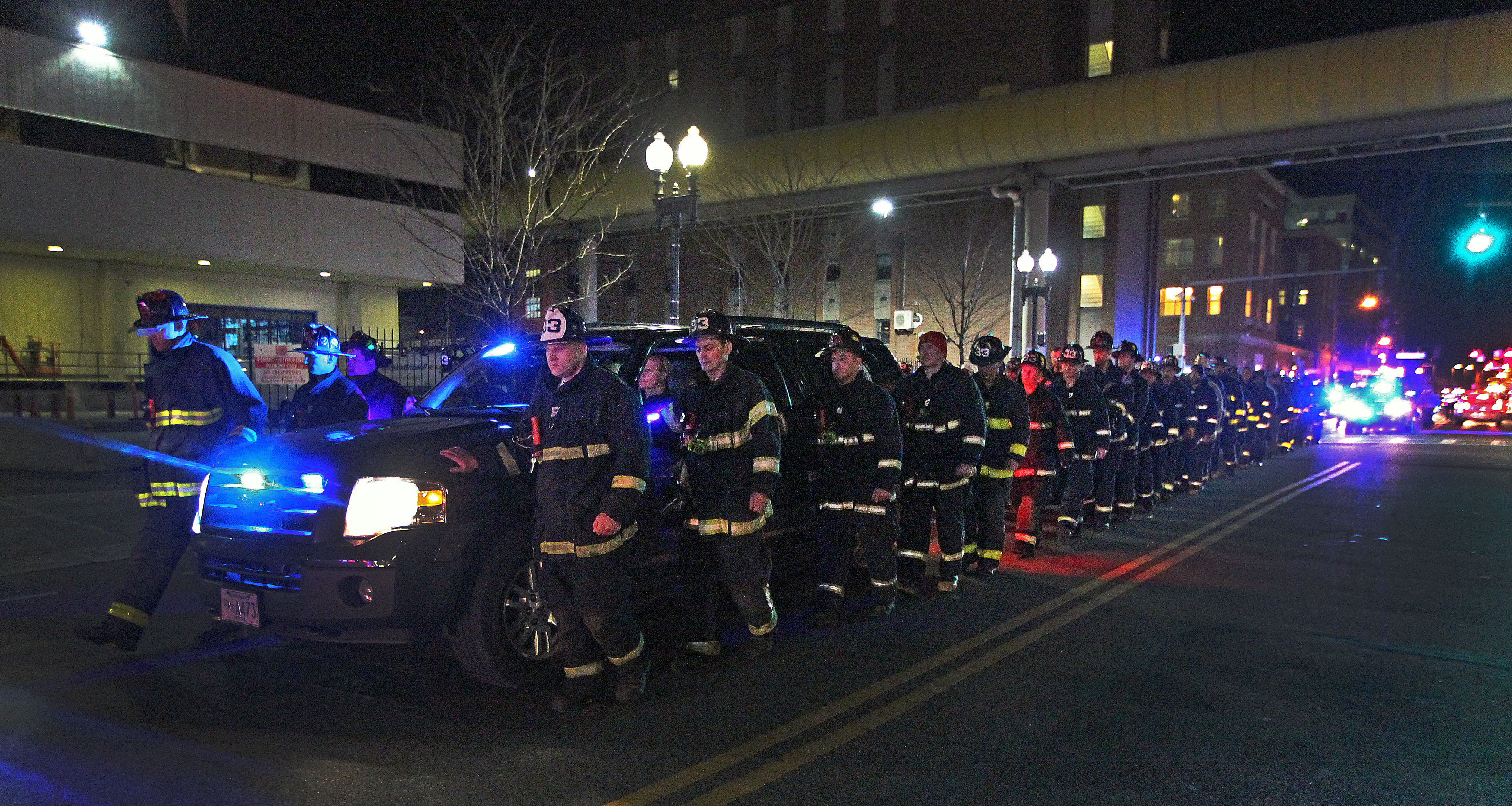 The body of one of the victims of Wednesday’s fire was escorted by fellow firefighters to the medical examiner’s office.