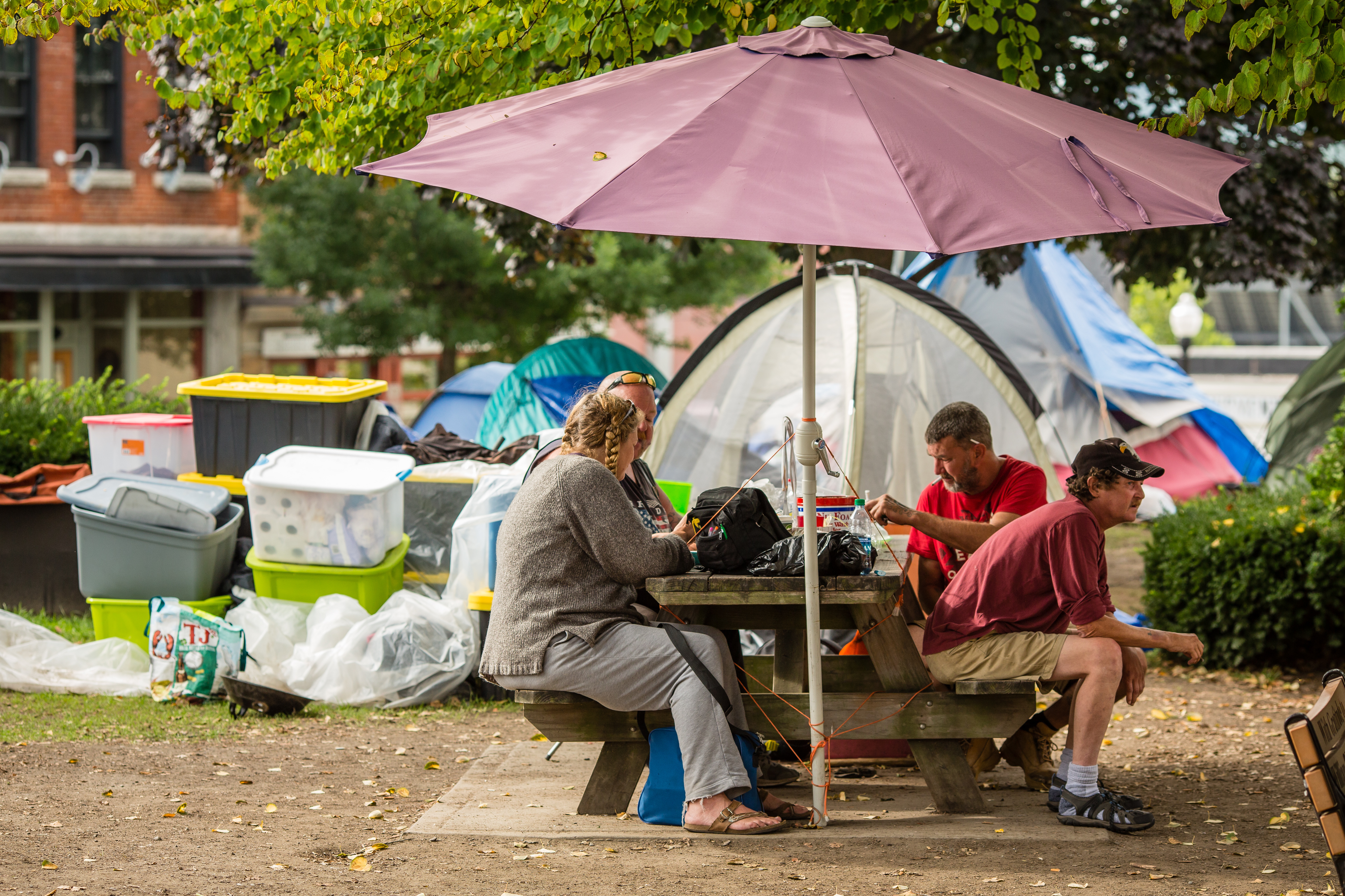 A group of homeless people sat around a picnic table on Greenfield's town common.