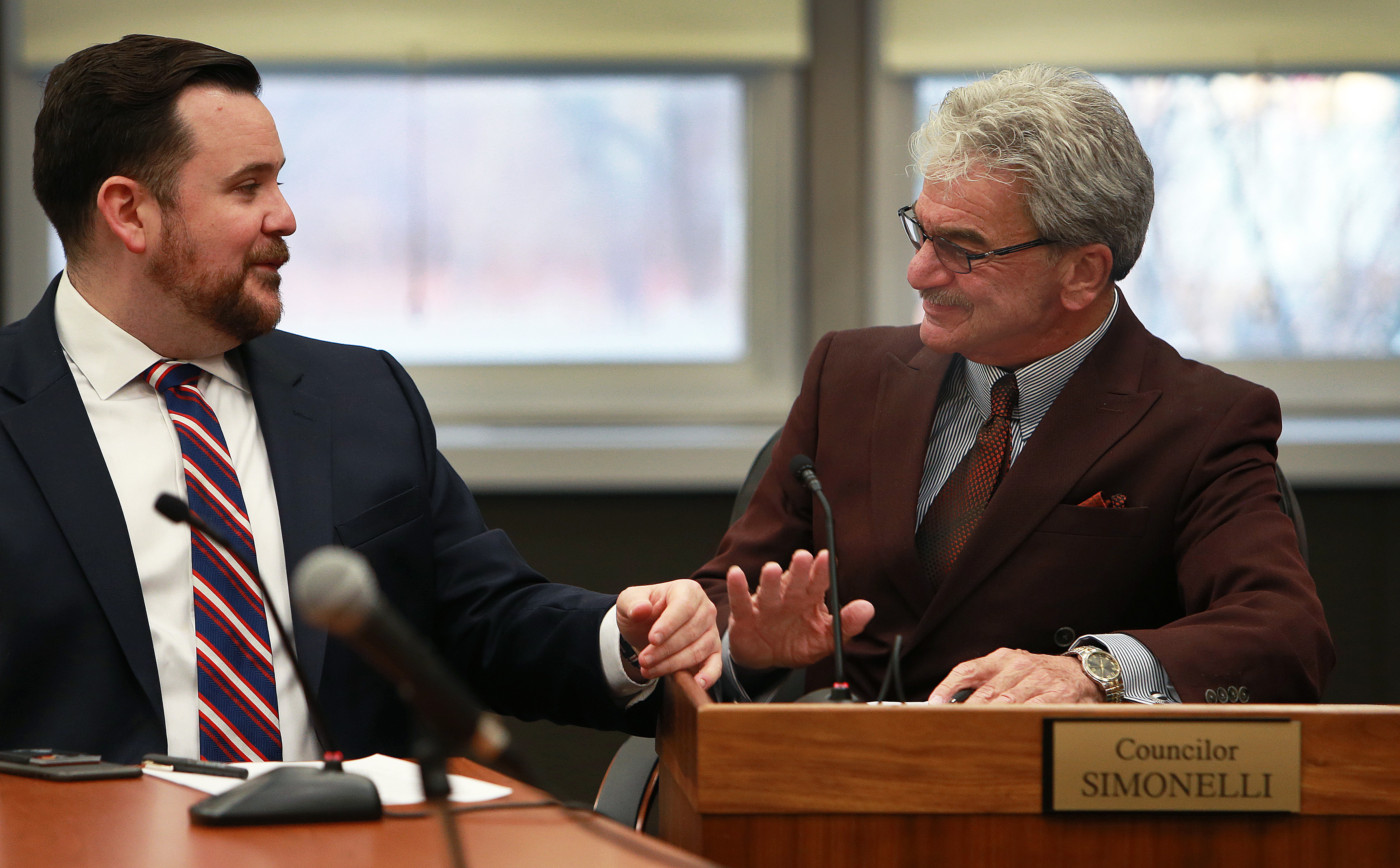 Everett City Councilor Steve Simonelli (right) with his nephew Shane at a council meeting. Simonelli has a hard time speaking at meetings, so his nephew handles speaking duties.