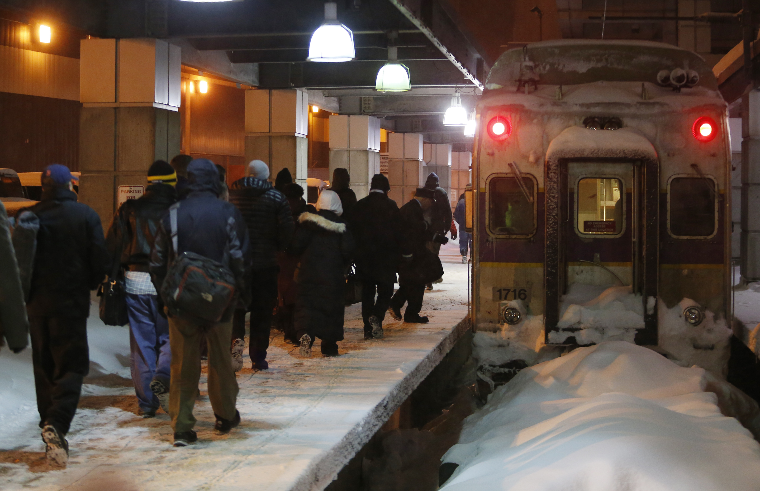 Travelers made their way to a commuter train at South Station.