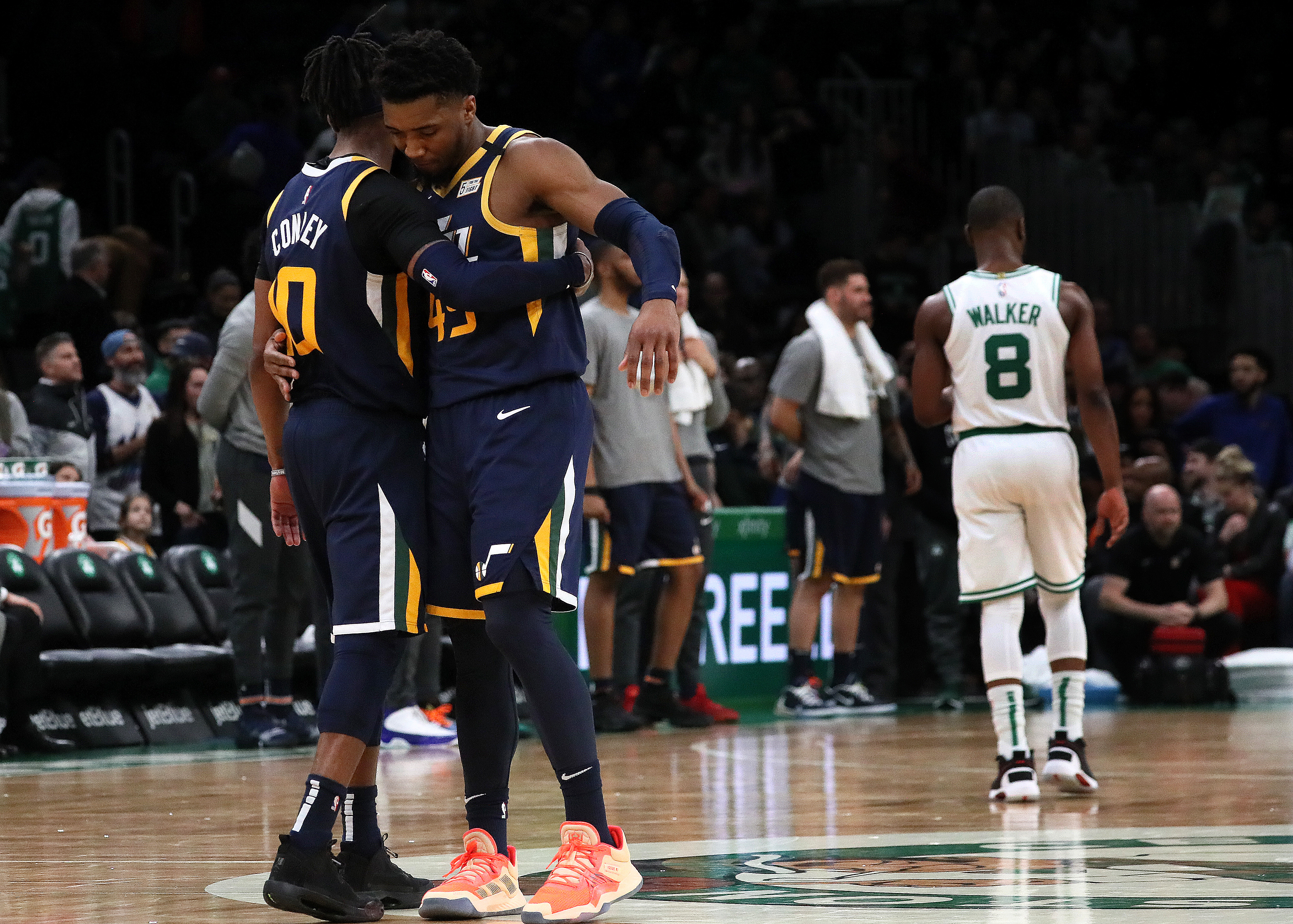 Mike Conley (10) and Donovan Mitchell (45) celebrate the 99-94 win on Friday at TD Garden.