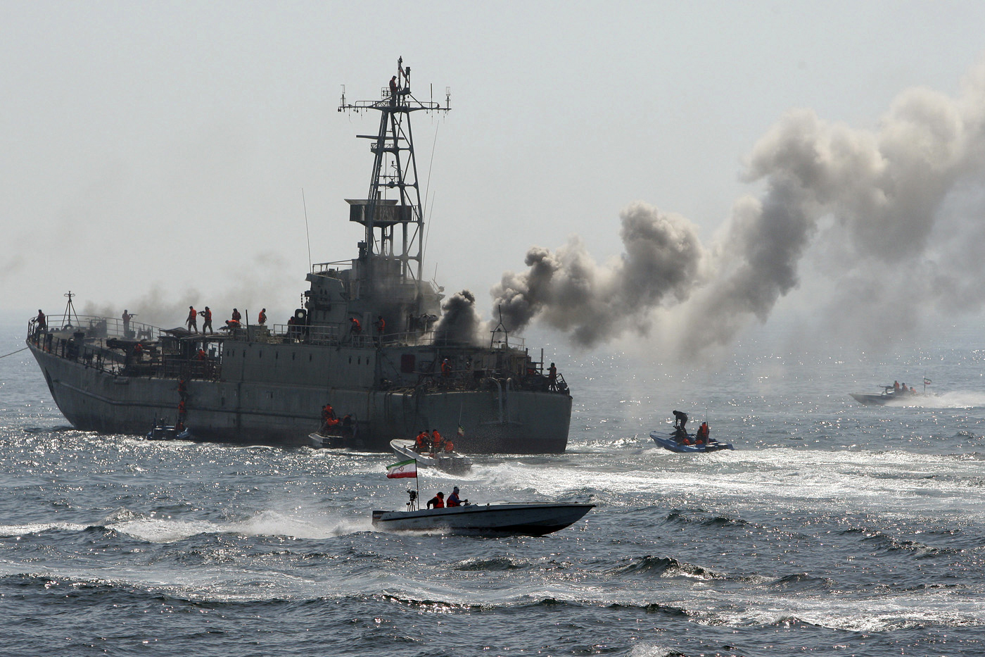Revolutionary Guard troops attack a warship being used as a target during maneuvers in the Persian Gulf.