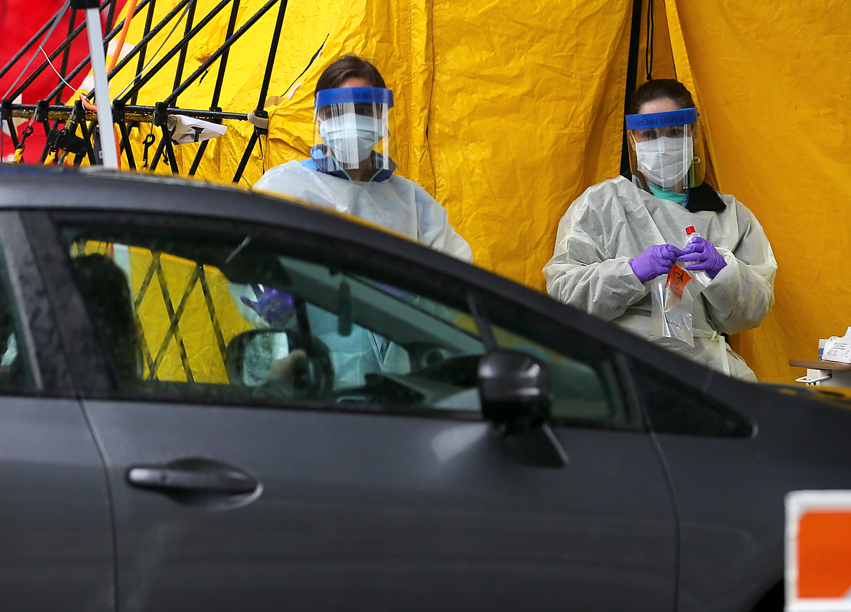 Drive-through testing for coronavirus at Cape Cod Community College by Cape Cod Healthcare nurses.