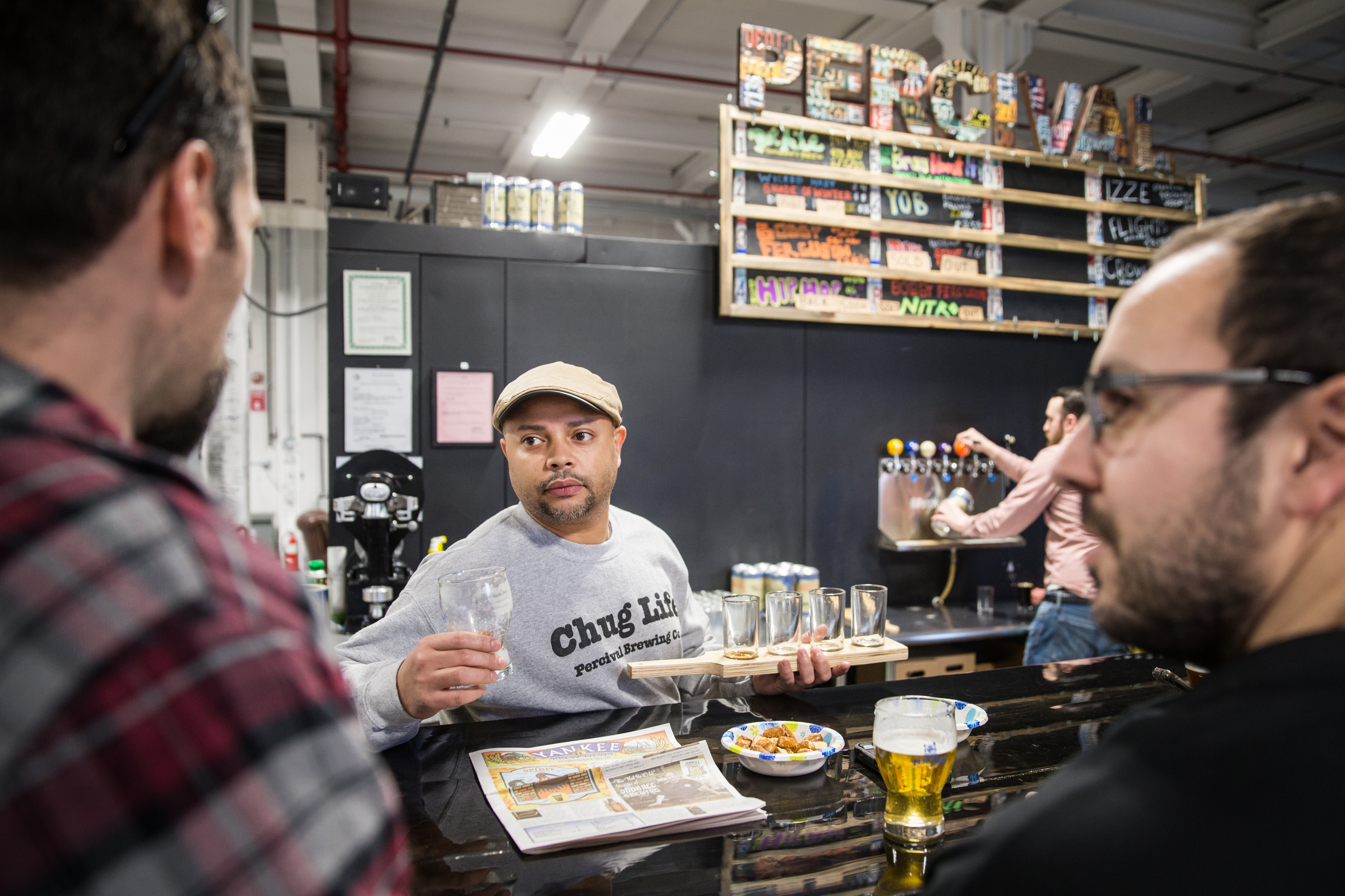 Owner Felipe Oliveira serves customers at Percival Brewing Company.