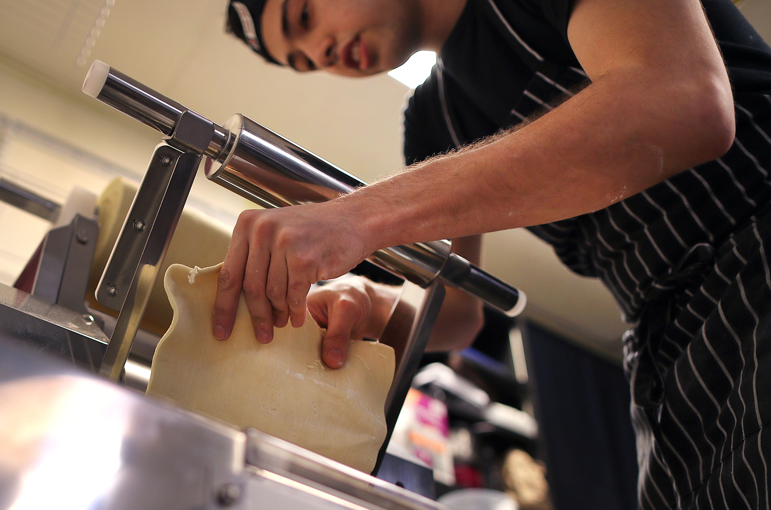 Cook Morgan Hote works with a homemade roll of dough used for the ramen noodles.