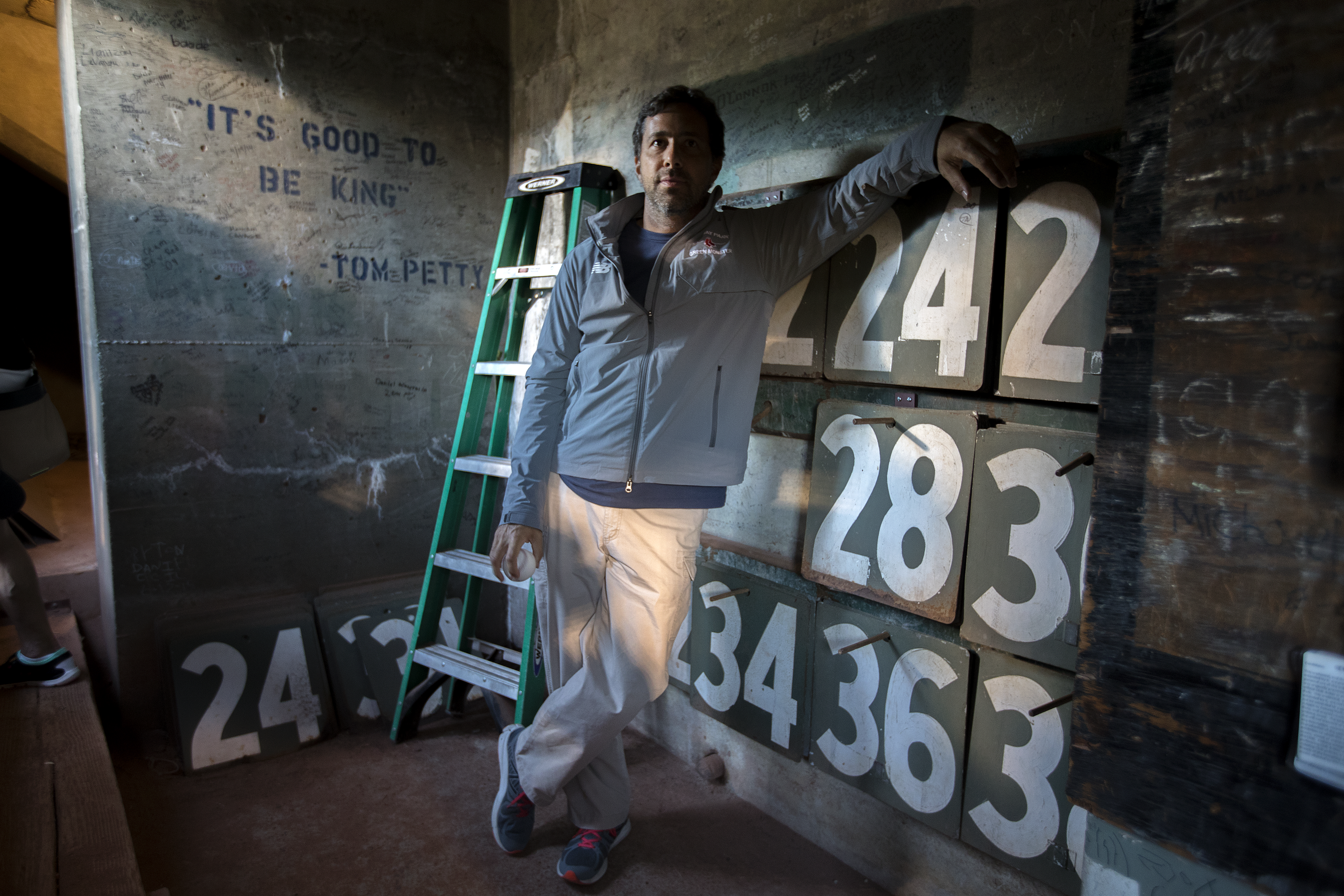 Christian Elias with the tools of his trade — a ladder and lots of numbers.