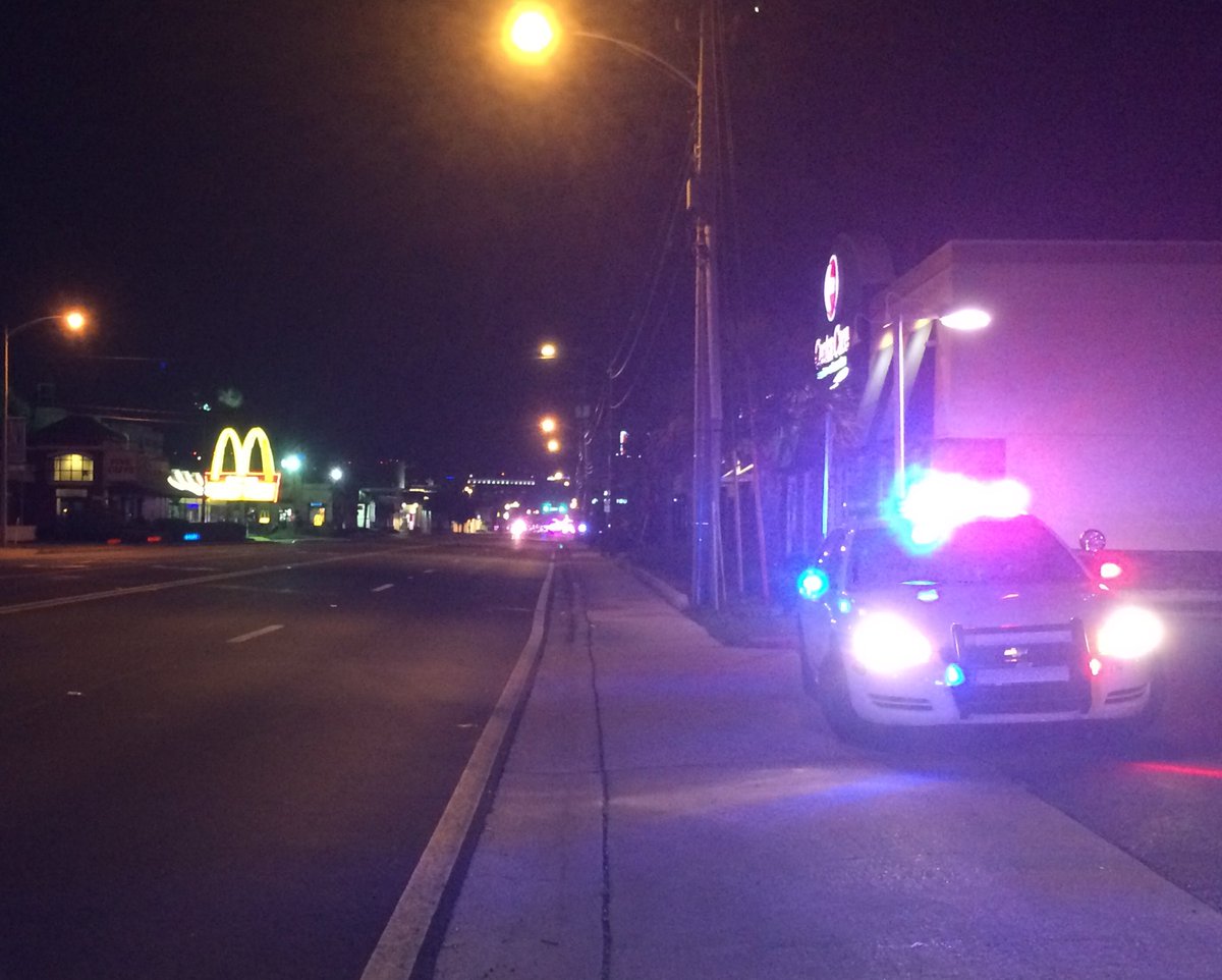 Police cars were near the scene of the shooting in Orlando early Sunday.