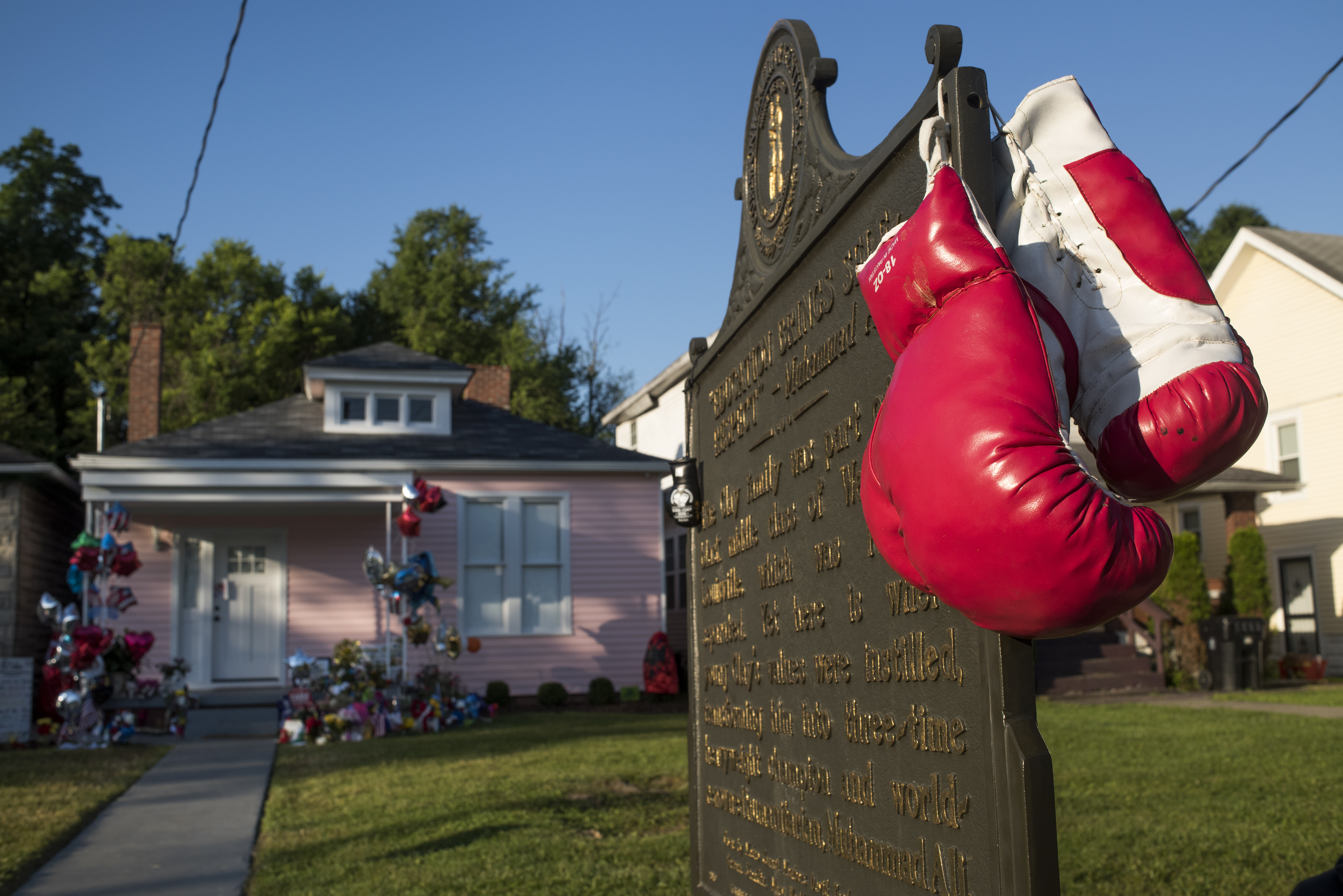 A pair of boxing gloves was placed on a historical marker in front of Muhammad Ali’s childhood home on Grande Avenue in Louisville, Ky.