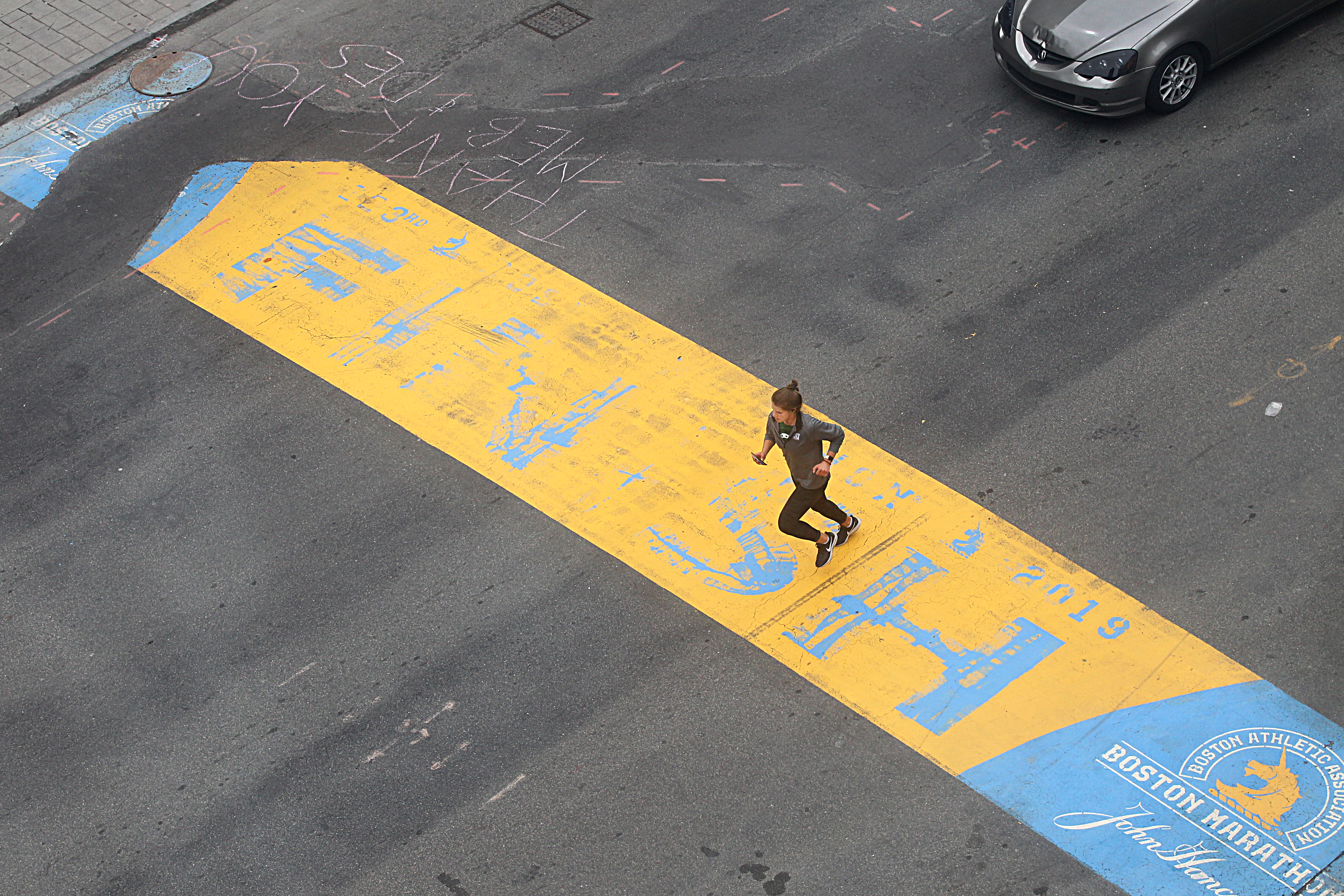 Some people ran across the Boston Marathon finish line on Boylston Street on Monday, but it was uncertain if they had run the entire route.