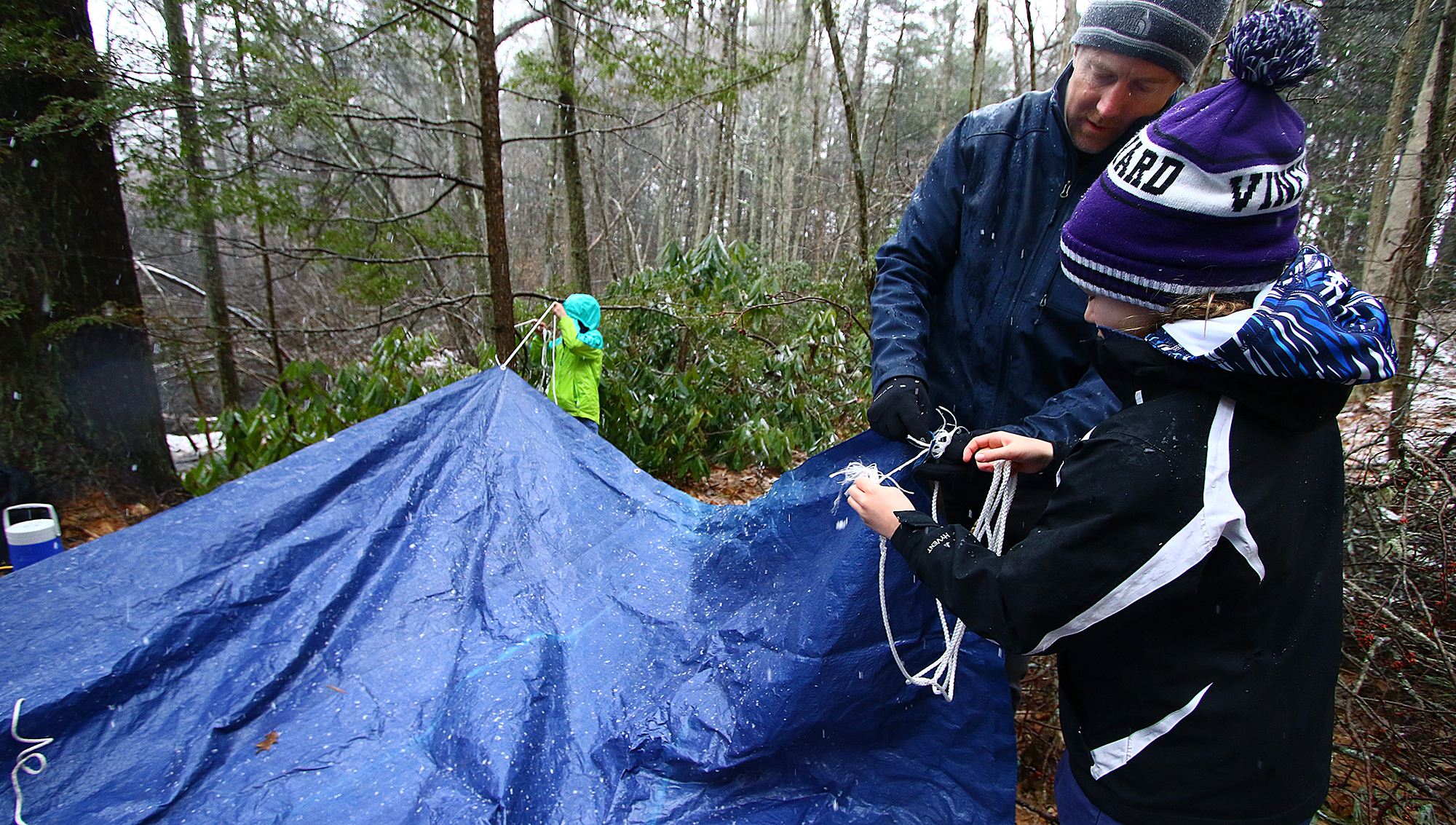 Todd Cooper teaches Lily Oliver how to make a shelter.