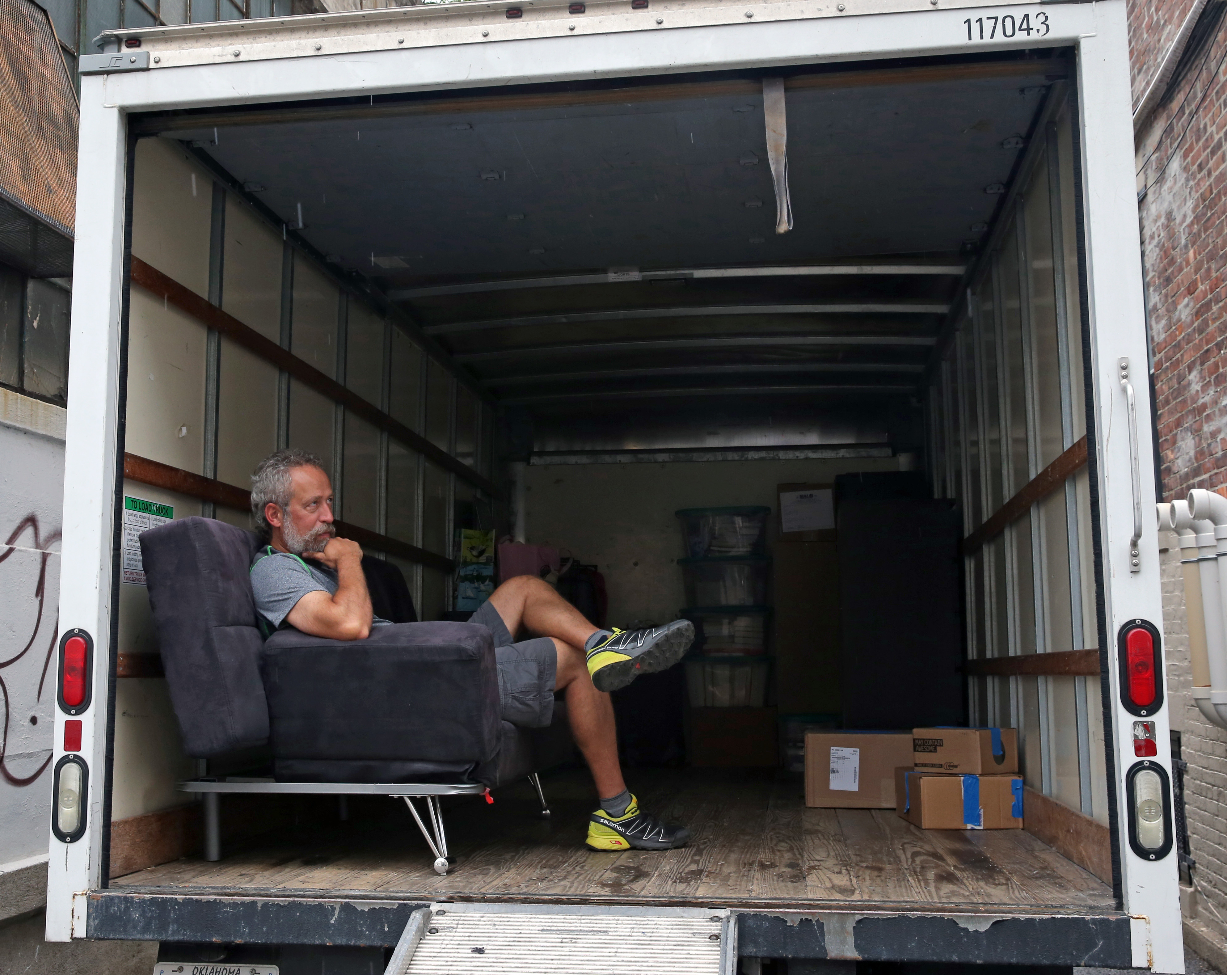 Armin Gunther, from Colorado, waited for his son on a coach in a moving van.
