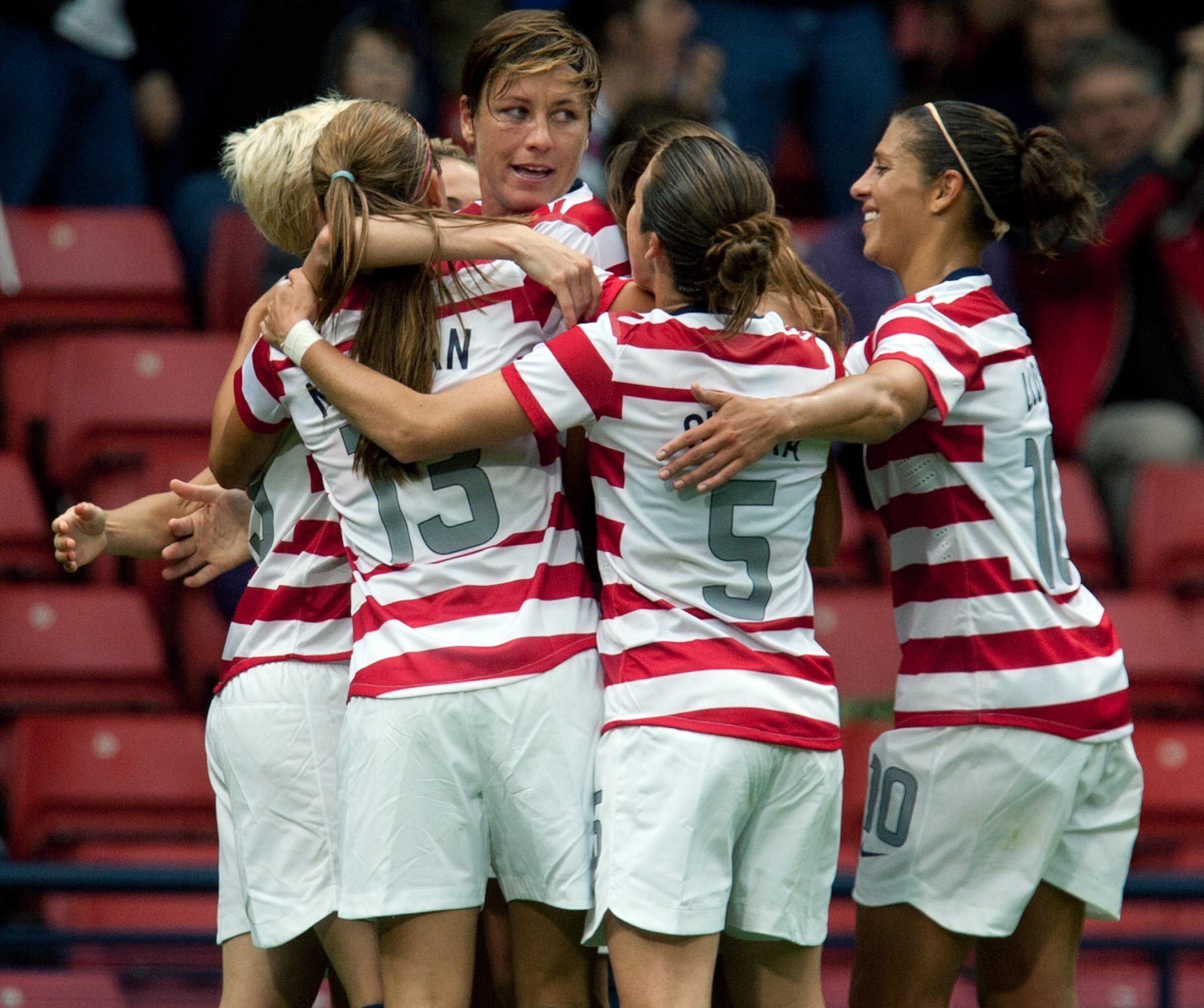 Teammates surrounded Abby Wambach, center, after her record-breaking goal against Colombia on Saturday.
