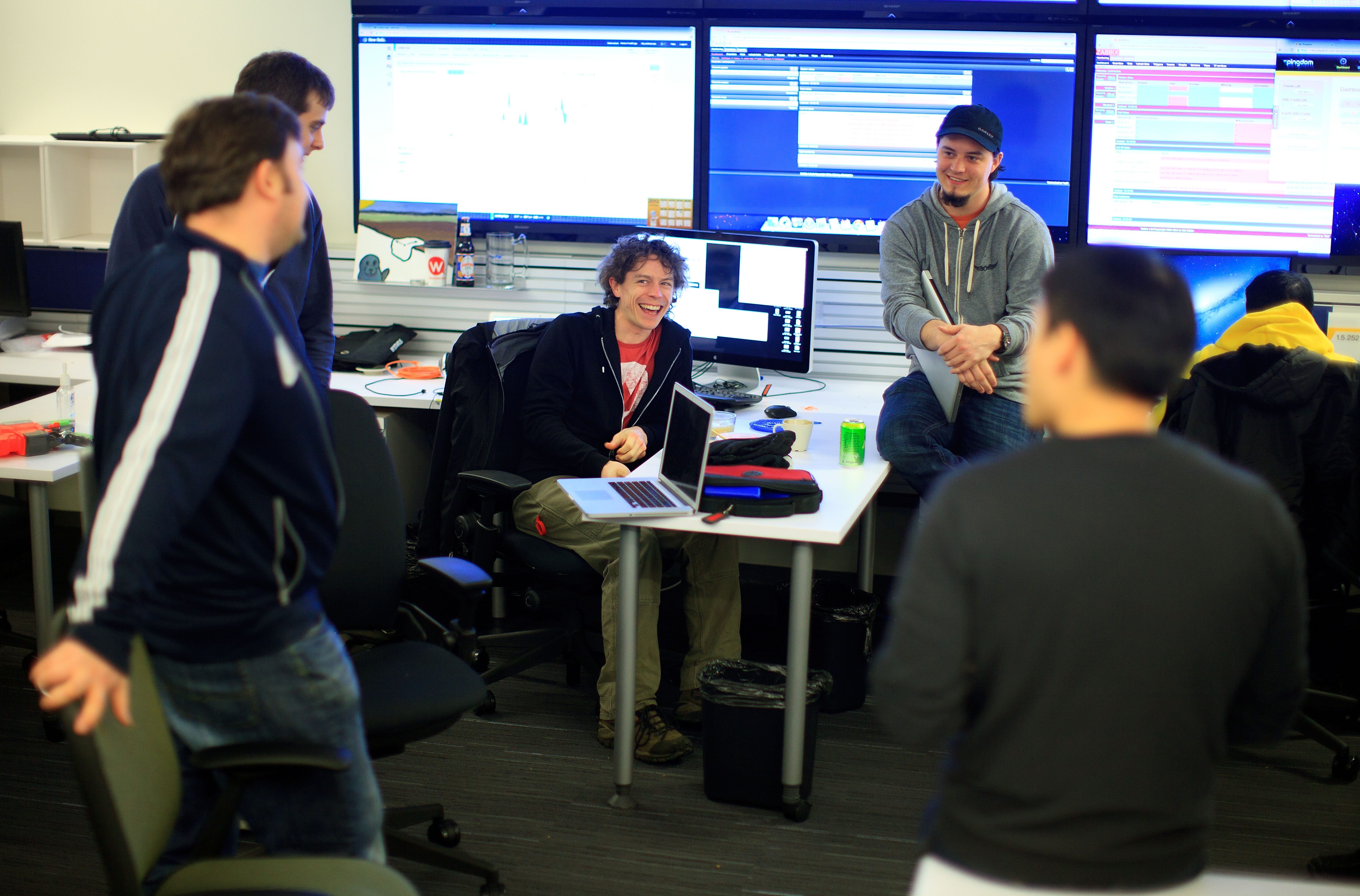 Eric Herot (center), a senior systems administrator, met with colleagues at PayPal’s new Boston office Wednesday.