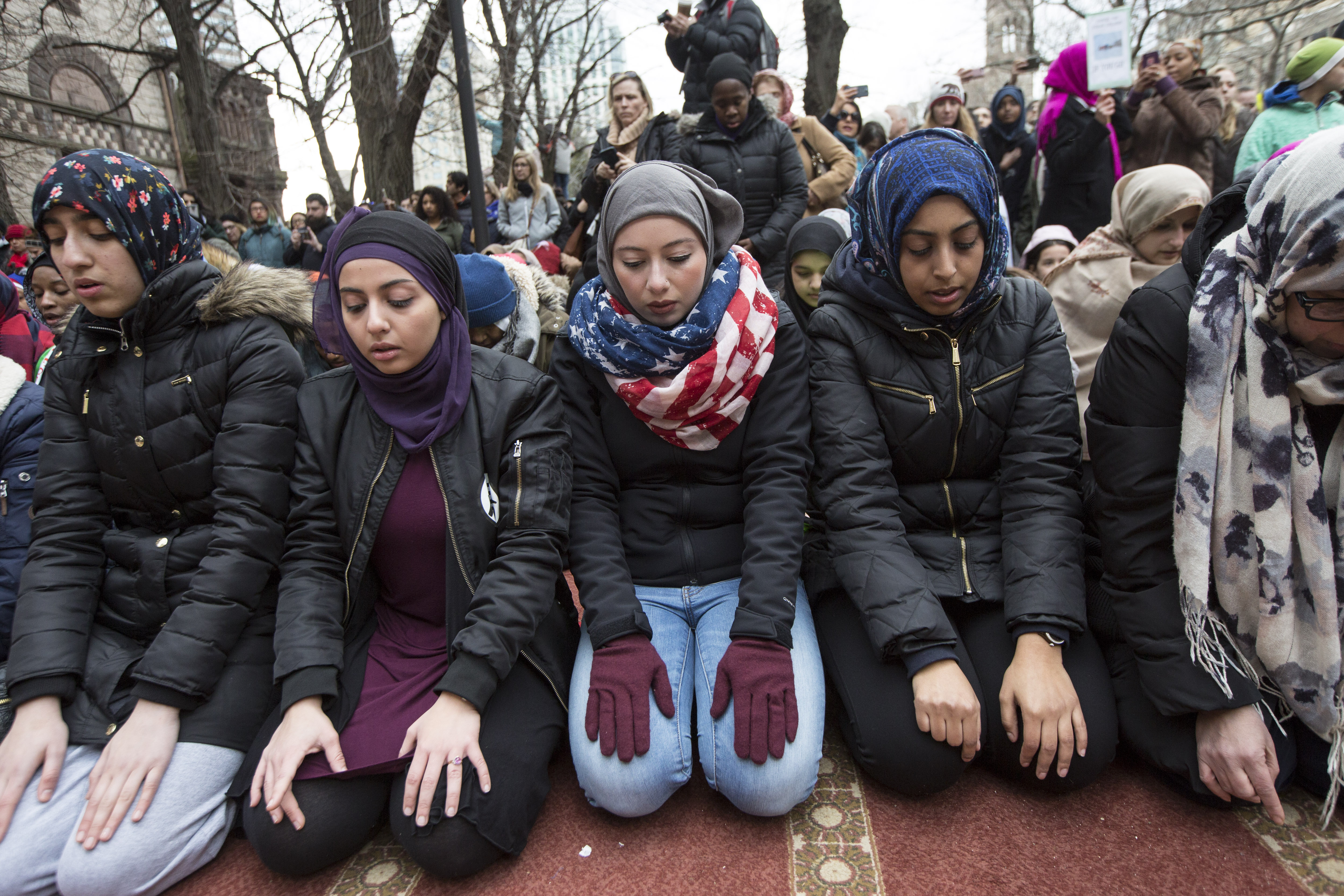 Muslim women prayed during a protest against President Donald Trump's executive order in Copley Square.