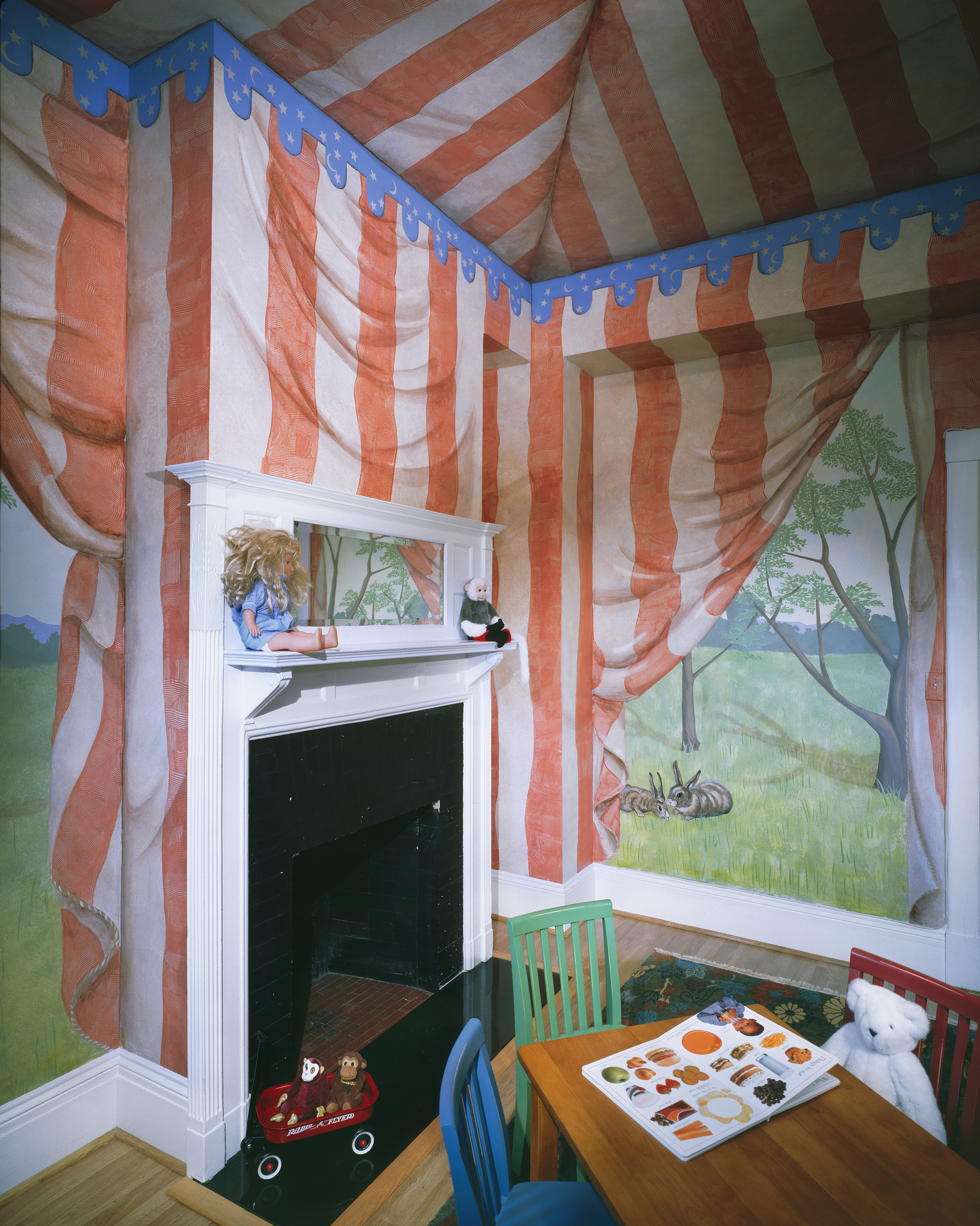 A trompe l’oeil mural of a tented canopy on a flat ceiling.