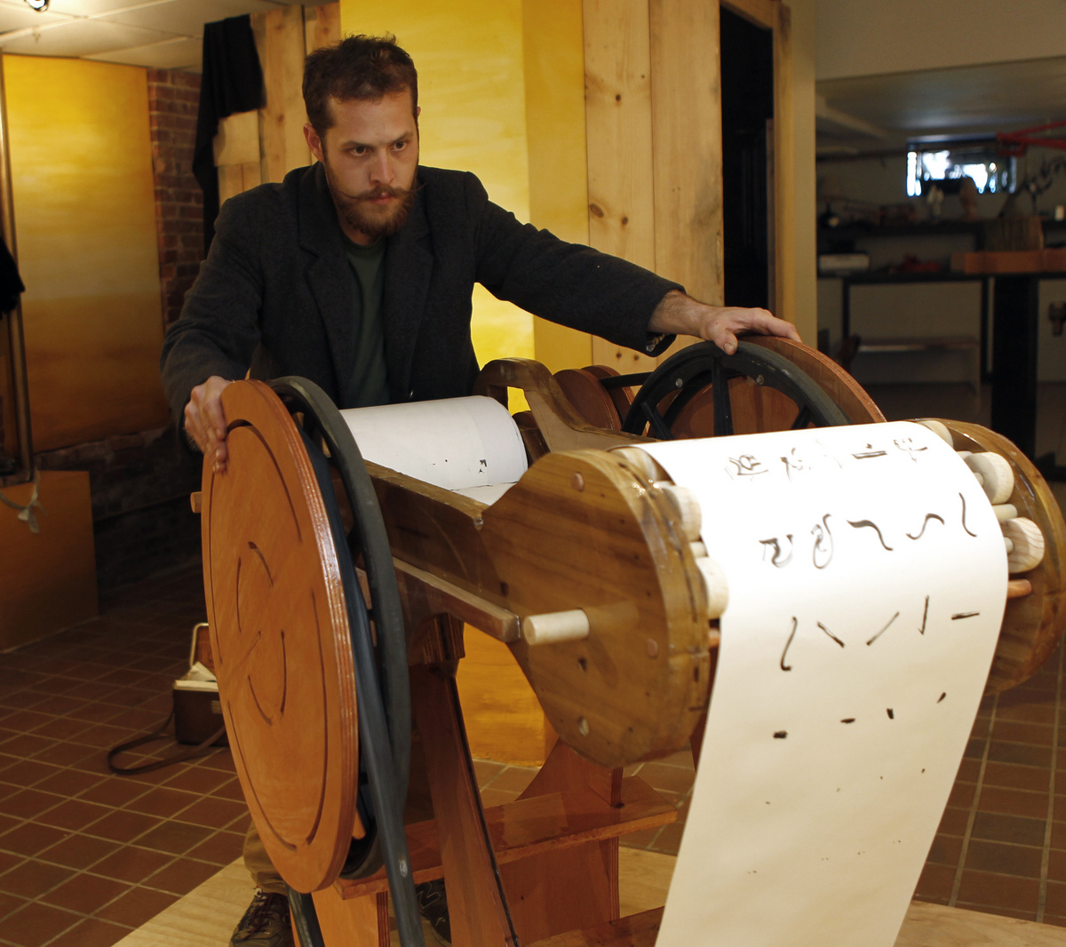 Adrian Molina with his piece “Emittime,’’ which is a scroll of different scenes that he painted.