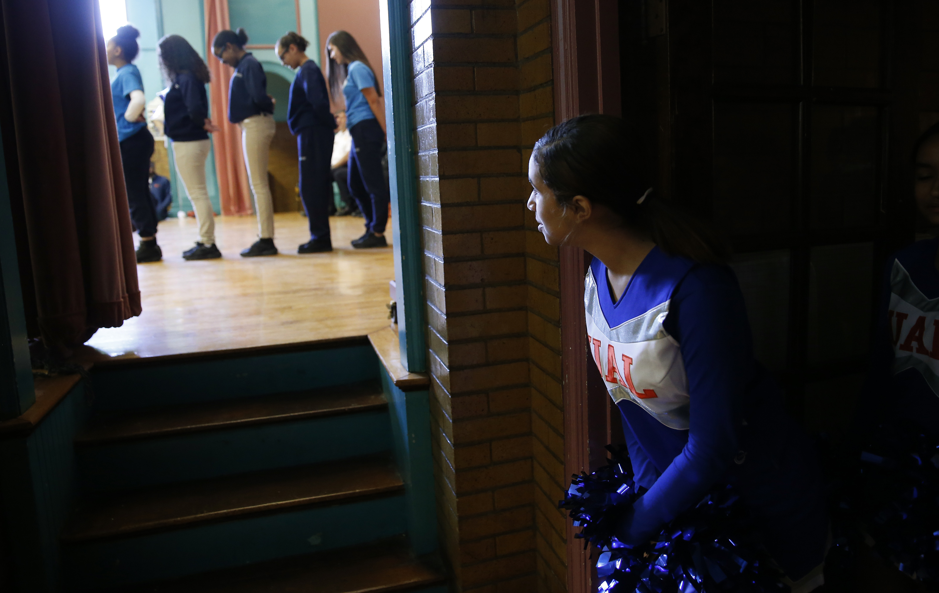 A cheerleader at Up Academy Leonard watched as the Step Team performed.