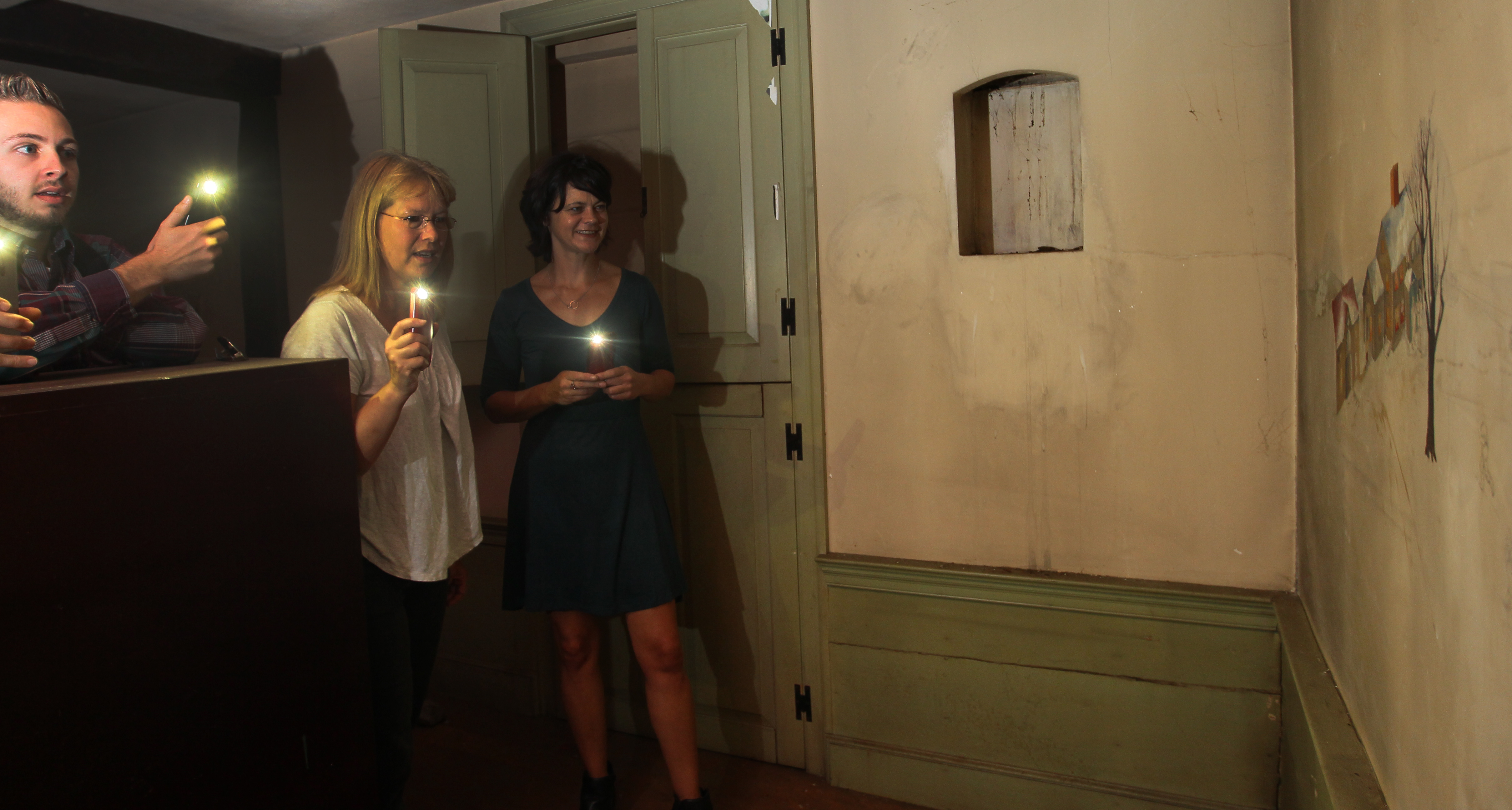 From left: Jackson Rand, Lisa Lewis, and Darci Schofield examined drawings on a wall at the Fowler Clark Epstein Farm.