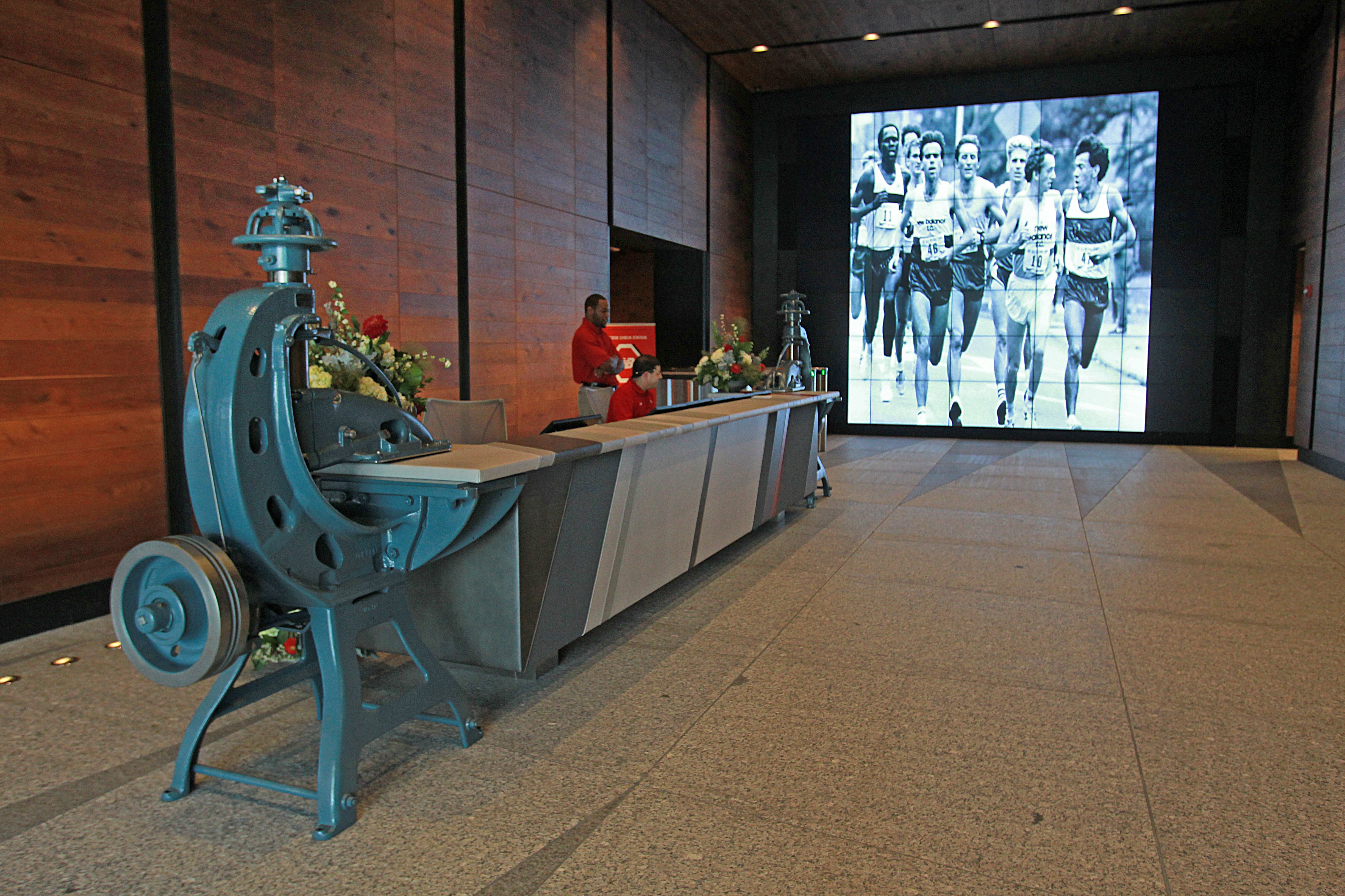 The lobby area of New Balance’s new headquarters features a large electronic display.