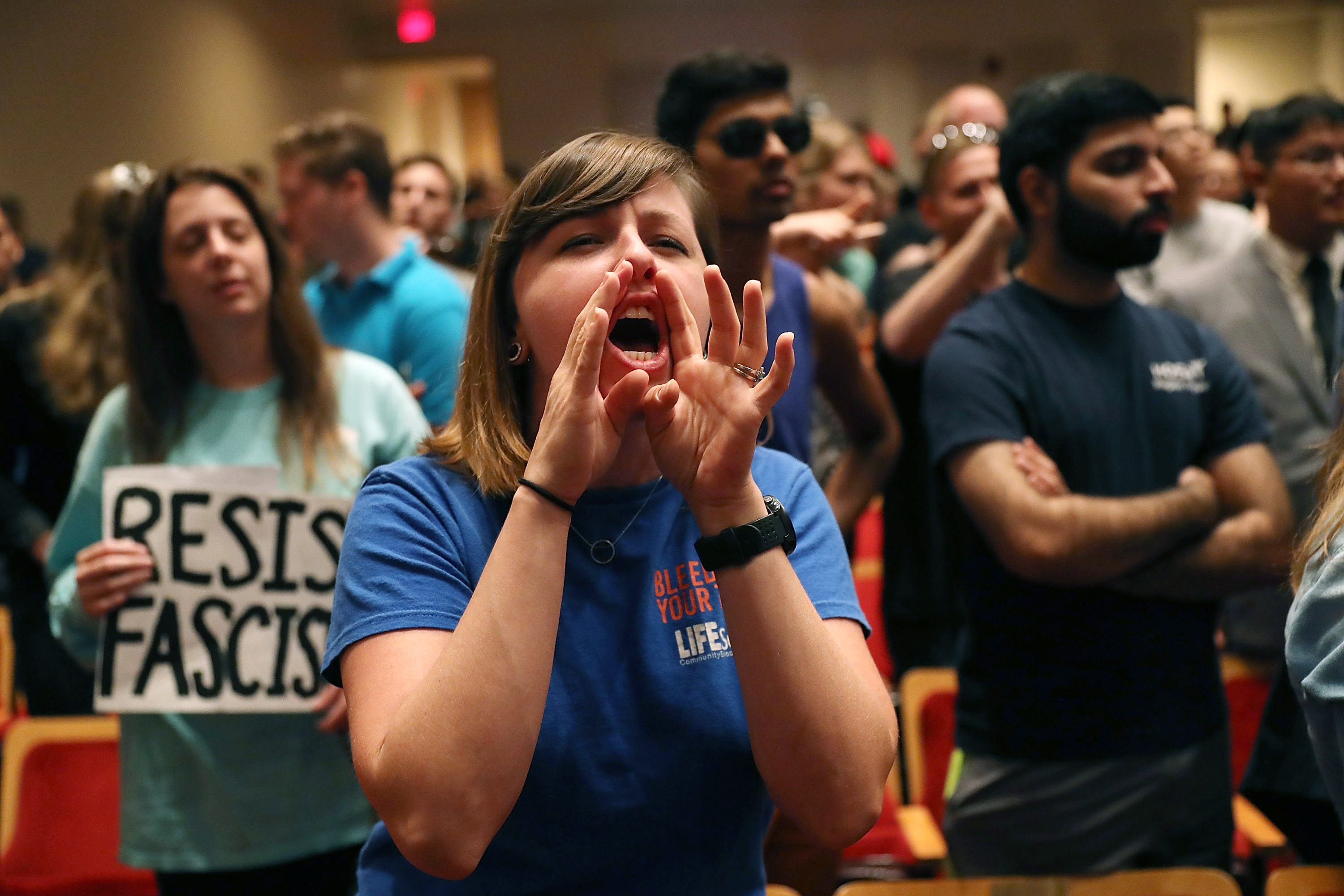 People reacted as white nationalist Richard Spencer spoke at the Curtis M. Phillips Center for the Performing Arts in Gainesville, Florida.