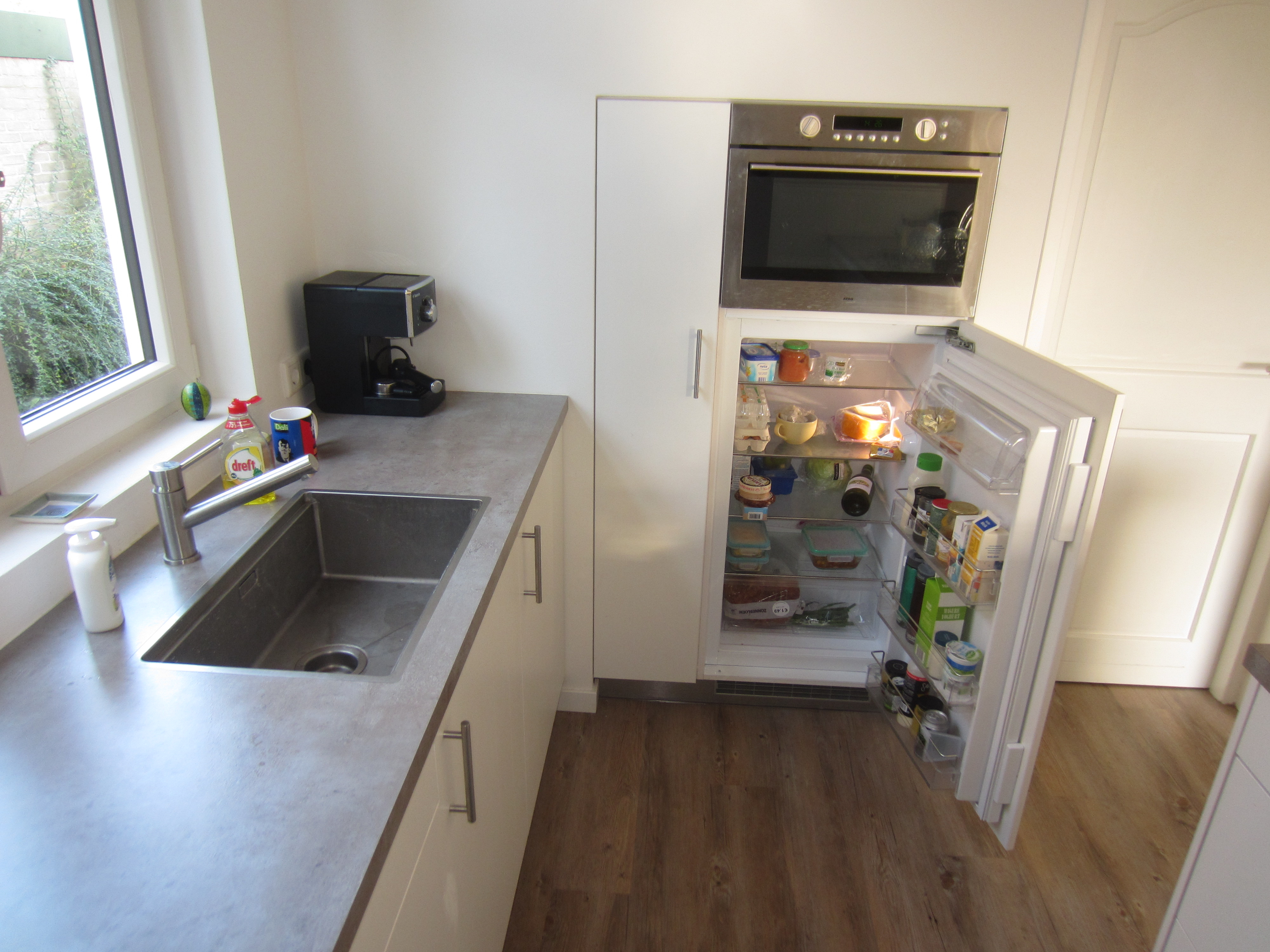 The Dutch refrigerator, without a freezer, and topped with a microwave/oven combination unit.