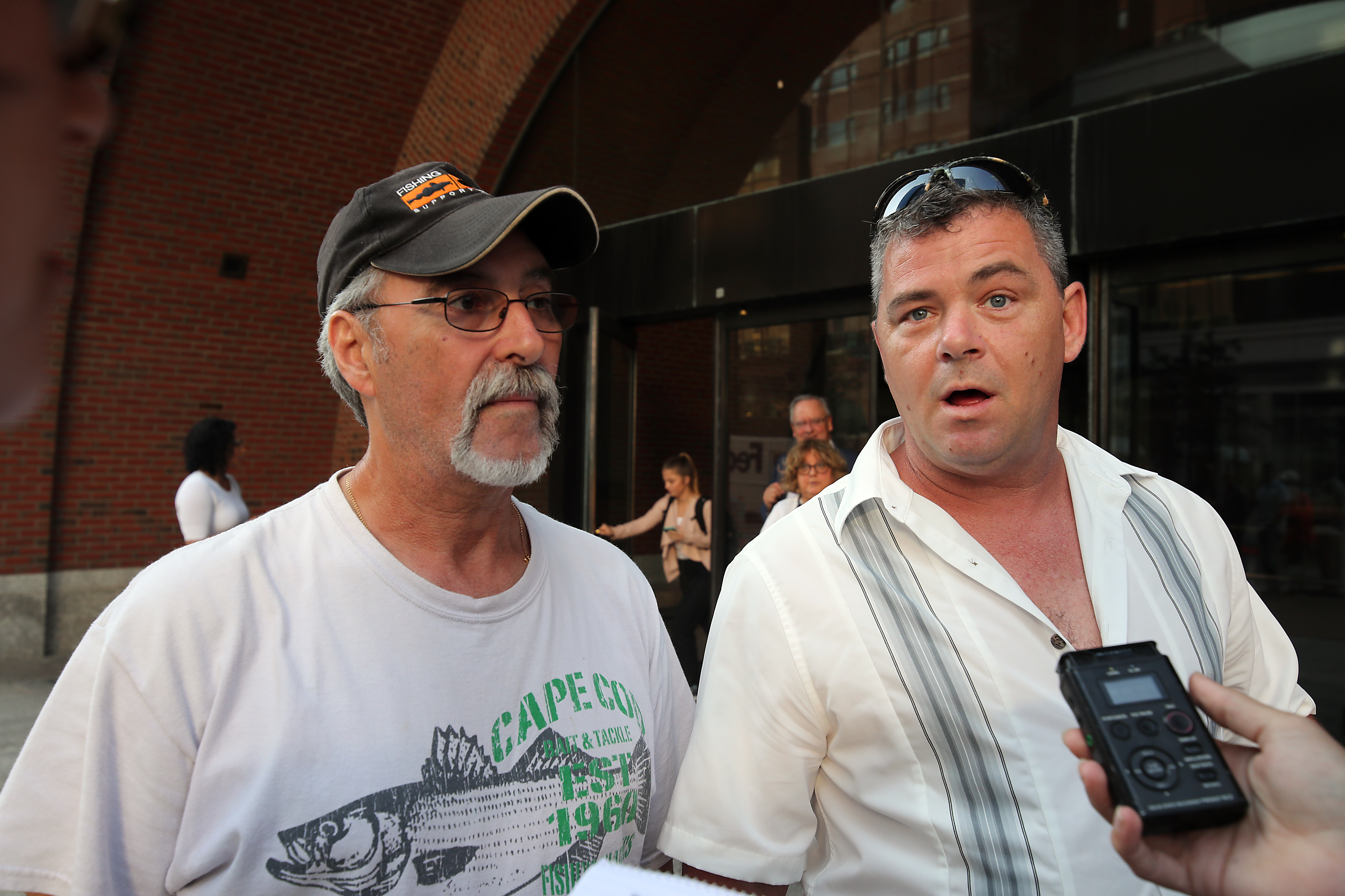 Tony Fernandes (left) and Shawn Machie, both captains on boats owned by Carlos Rafael, spoke outside the courthouse.