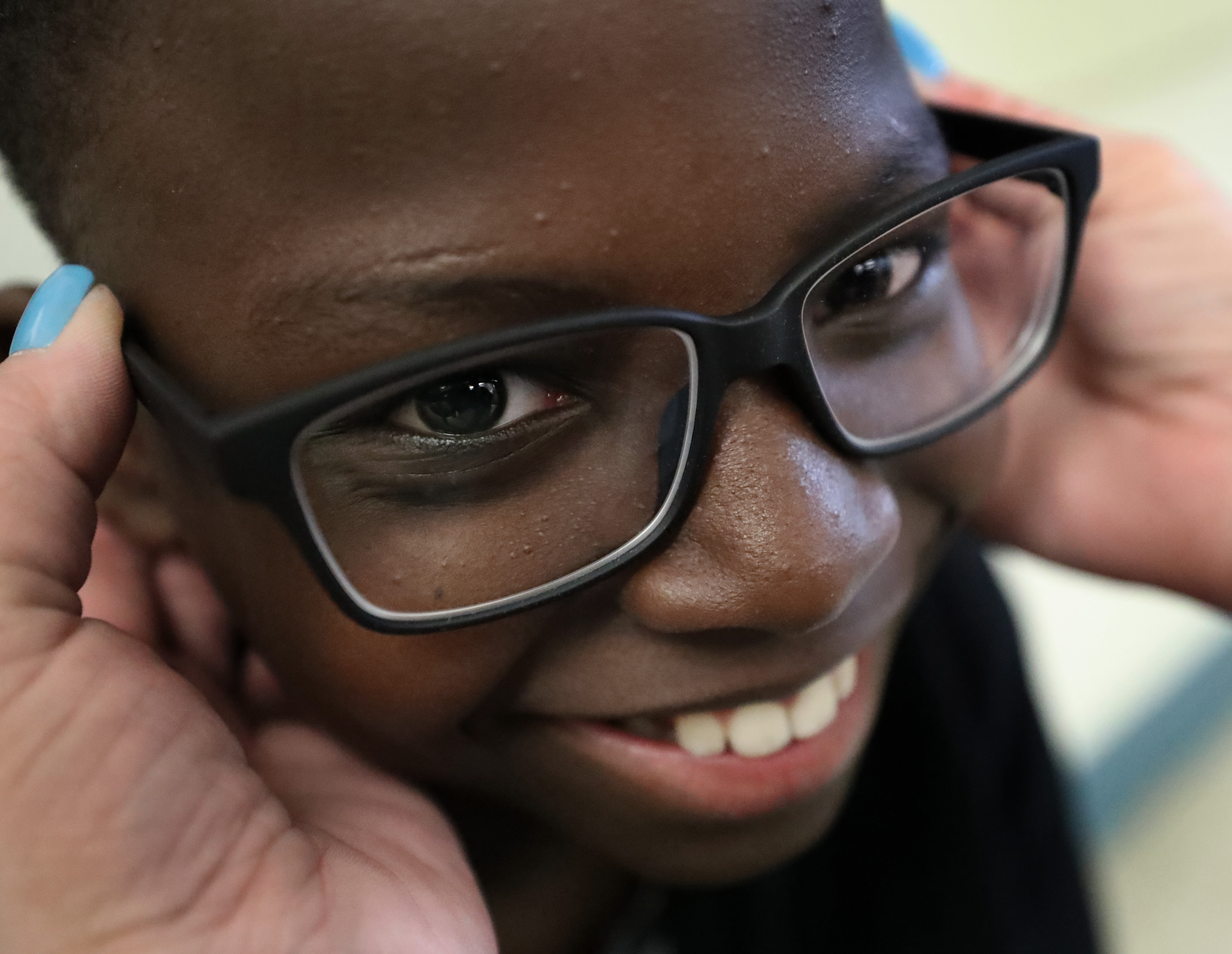 Joshua Jean Charles was all smiles after getting his glasses.