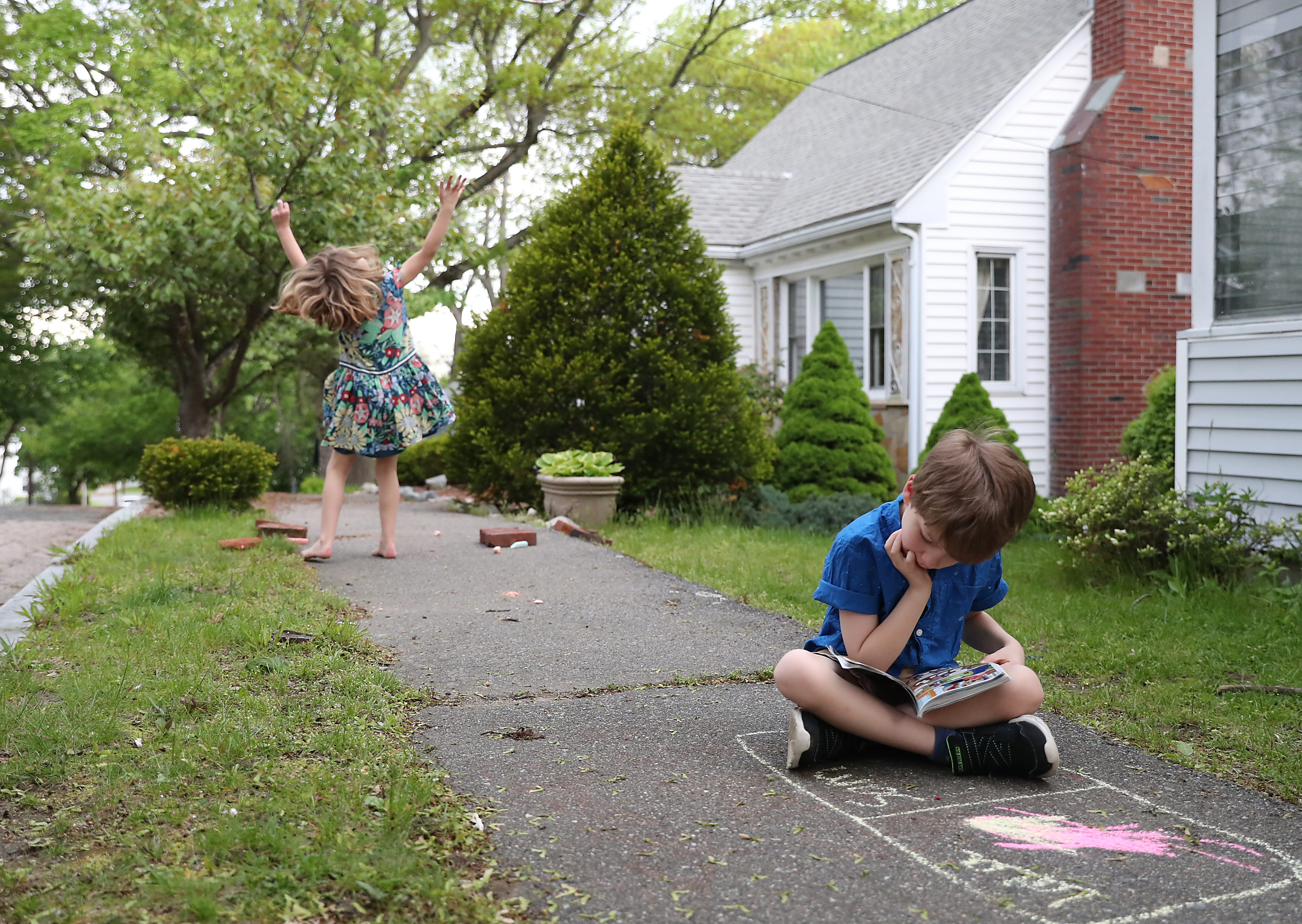 Ella Bardwell danced with herself as her twin brother, Sam Bardwell read a comic book.