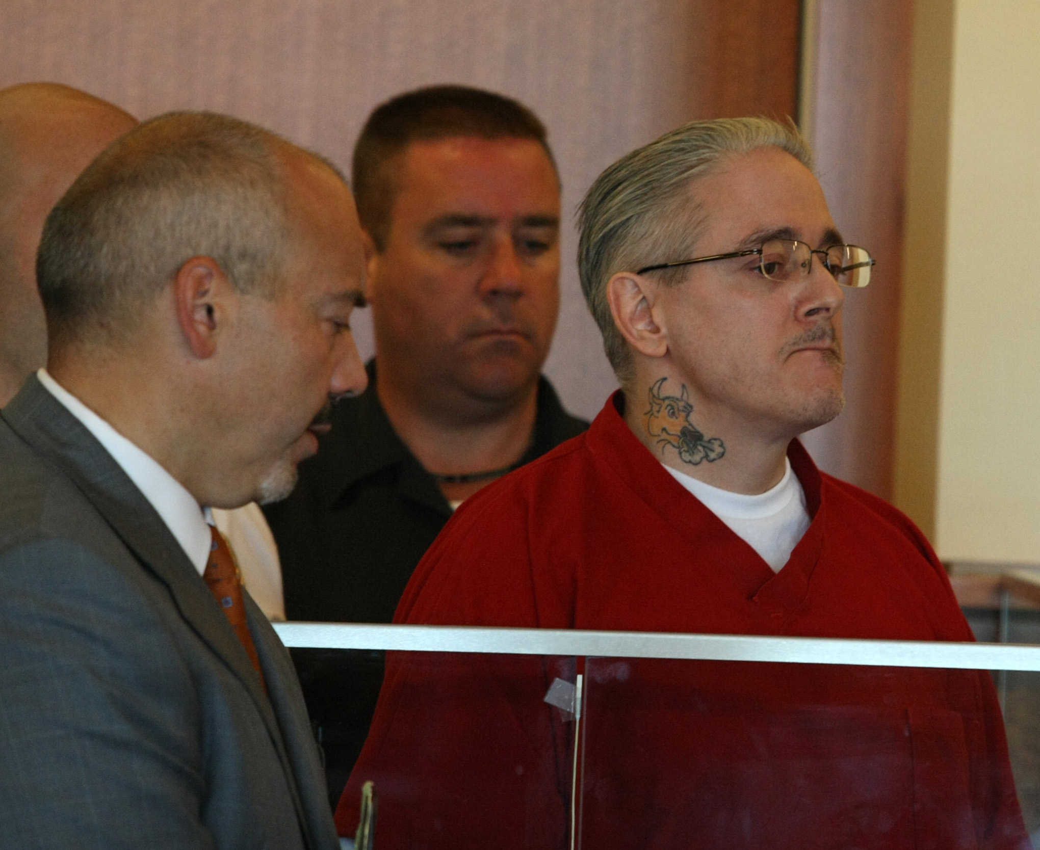 Daniel T. Tavares Jr. (right) appeared at his arraignment in September 2013.