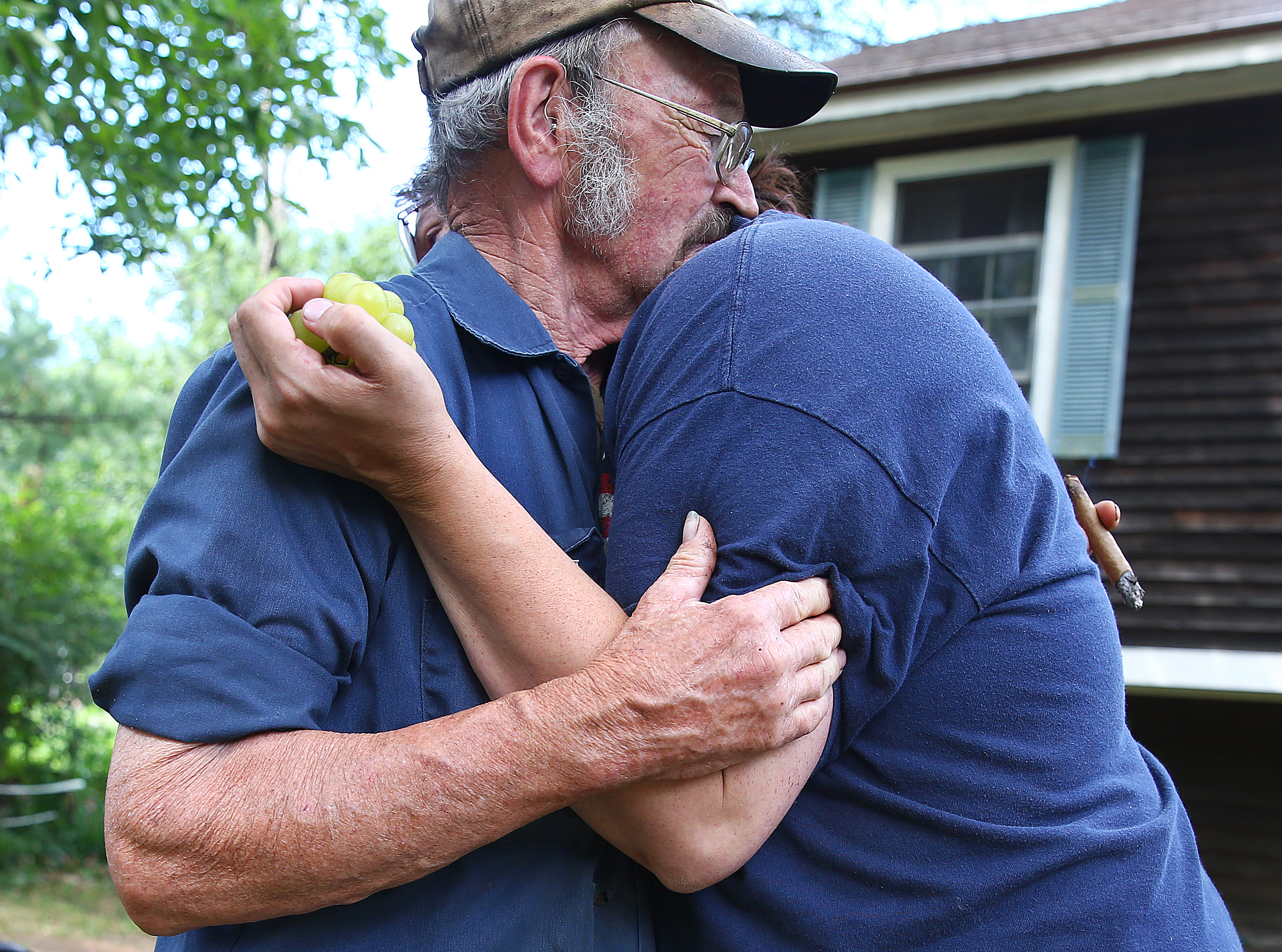 The victim’s grandfather Charles Carter was embraced by his son’s girlfriend, Karlena Henry.