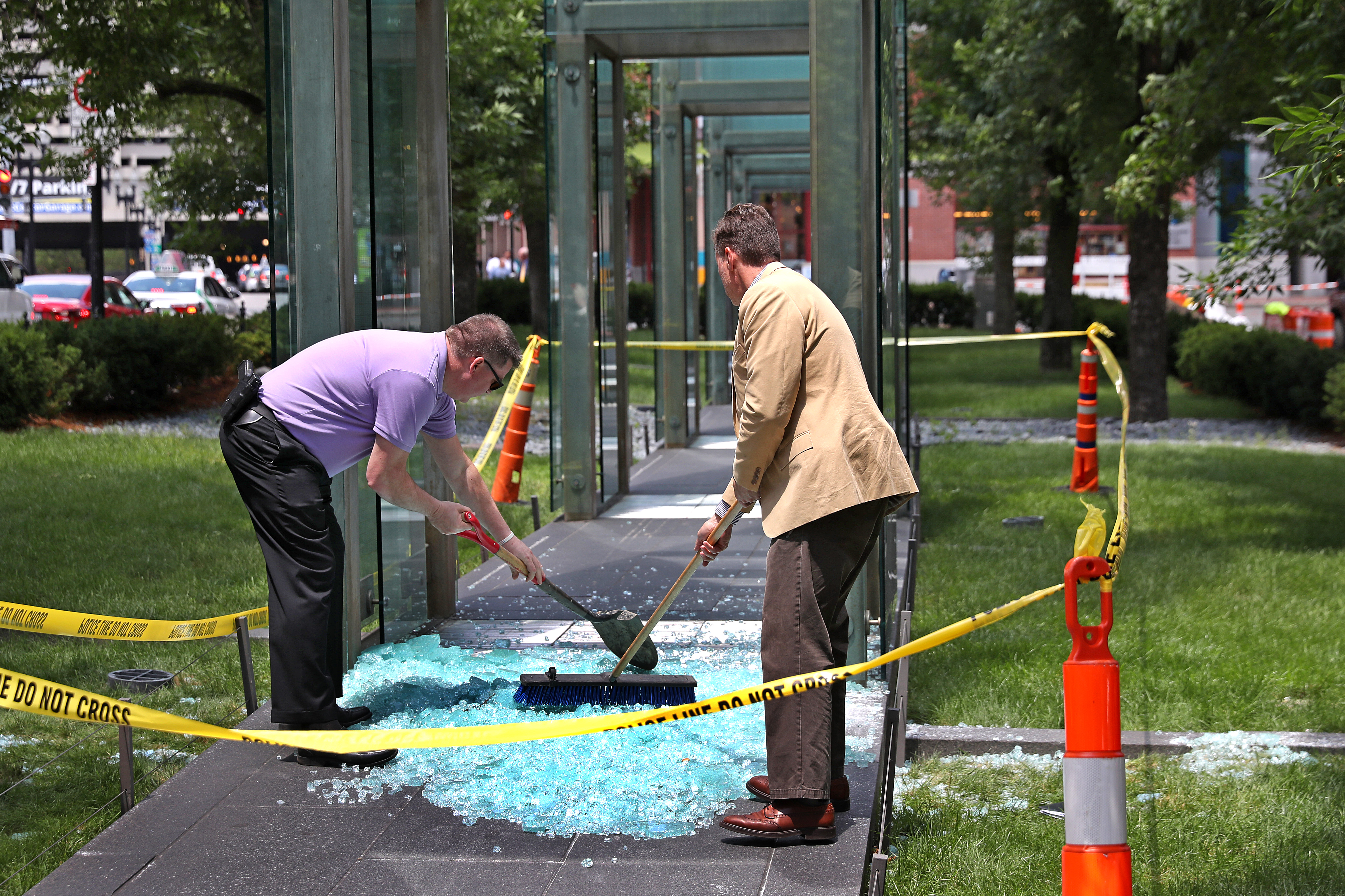 Boston Police detective searched through the broken glass for evidence.