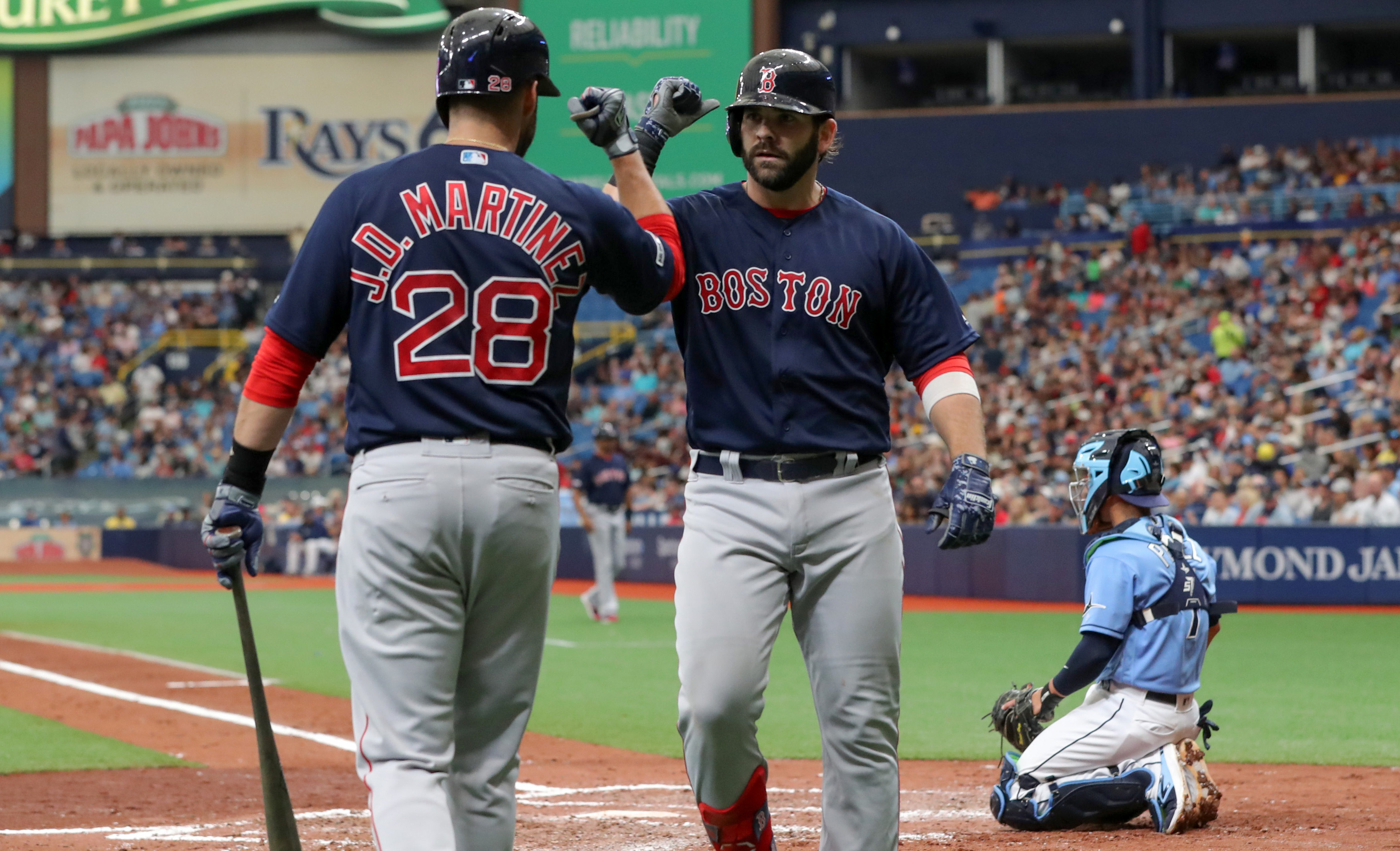 J.D. Martinez congratulates Mitch Moreland after his fourth-inning home run on Sunday against the Rays in St. Petersburg, Fla.